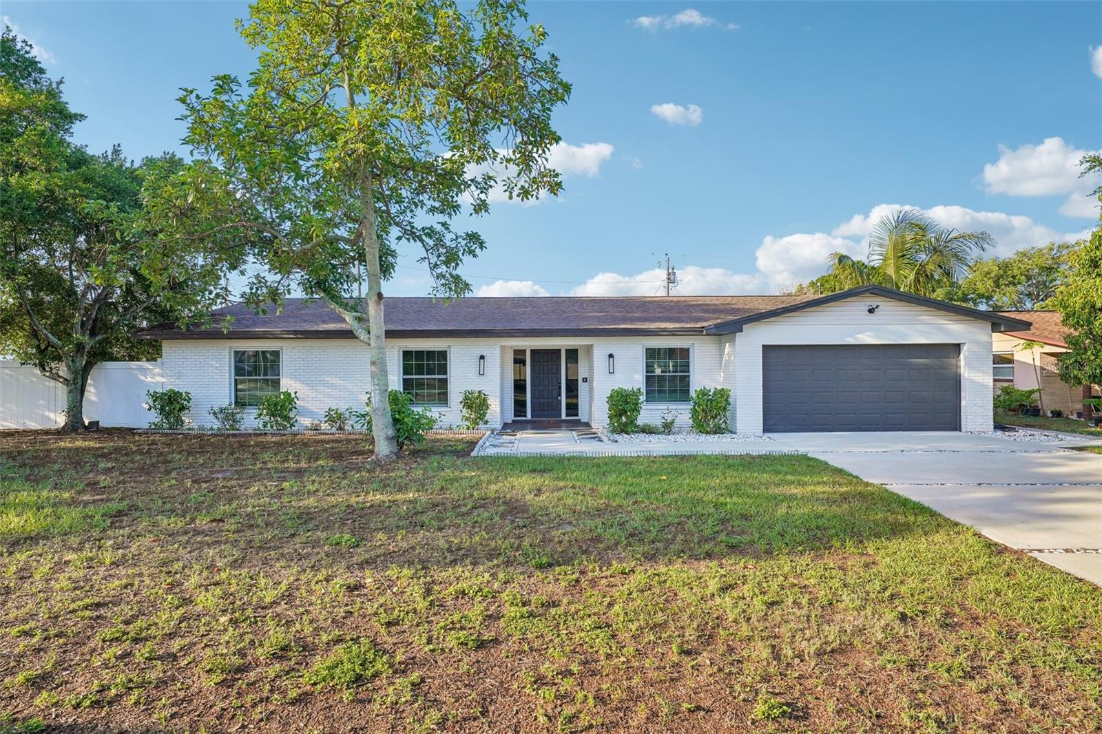 Welcome to the kind of home that rarely comes available, your own private slice of Florida paradise where modern renovations, a flexible floorplan, and outdoor living come together seamlessly. This beautifully renovated 5-bedroom, 3-bathroom POOL home offers just over 2,500 sqft of indoor living space on a large fenced corner lot in the heart of Seminole. Fully renovated in 2023 with no expense spared, this home comes complete with TWO ensuite retreats, a split bedroom floorplan, and a 2-car garage all designed with functionality in mind. Sitting on 0.22 acres of land, this home immediately impresses with low maintenance curb appeal and an oversized yard built for enjoying the Florida lifestyle year-round. Stepping inside, the foyer opens to a bright and expansive open concept floorplan filled with natural light, recessed lighting, and luxury vinyl plank flooring flowing seamlessly throughout the home. The large window-lined dining room sits just off the kitchen creating the perfect setup for entertaining family and friends. The stunning chef’s kitchen is truly the centerpiece of the home showcasing quartz countertops with extensive prep space, oversized island with pendant lighting and barstool seating, stainless steel appliances, vent hood, and abundant cabinetry for storage. This thoughtfully designed floorplan offers two private ensuite retreats ideal for multigenerational living, guests, or added privacy. Both ensuites feature modern finishes including dual sink vanities, stand-up showers, and beautiful floor-to-ceiling tilework. The additional guest bedrooms are generously sized while the third full bathroom offers dual sinks and a tub/shower combination. A large indoor laundry room adds even more convenience to the home. French doors lead out to the oversized vinyl fenced backyard where part of the yard has been astro turfed for low maintenance living. Paver decking surrounds the heated pool creating the perfect outdoor setup for relaxing, entertaining, or enjoying sunny Florida days all year long. Major upgrades have already been completed including a roof replacement and impact windows in 2019 along with a water heater replaced in 2025 offering peace of mind for years to come. Located in unincorporated Seminole and zoned for highly sought-after Bauder Elementary within the Seminole School District, this location places you just minutes from everything locals love most about the Gulf Coast. Enjoy easy access to award-winning beaches including Madeira Beach, Indian Shores, and Redington Beach along with Seminole City Center, local restaurants, shopping, movie theater, and everyday conveniences nearby. Outdoor enthusiasts will appreciate being close to the Pinellas Trail, Boca Ciega Millennium Park, and Walsingham Park offering trails, playgrounds, picnic areas, and scenic Florida beauty year-round. Whether it’s boating, beach sunsets, dining locally, or enjoying community events, this home offers a true Florida lifestyle while remaining high and dry without sacrificing proximity to the coast. Schedule your showing today!
