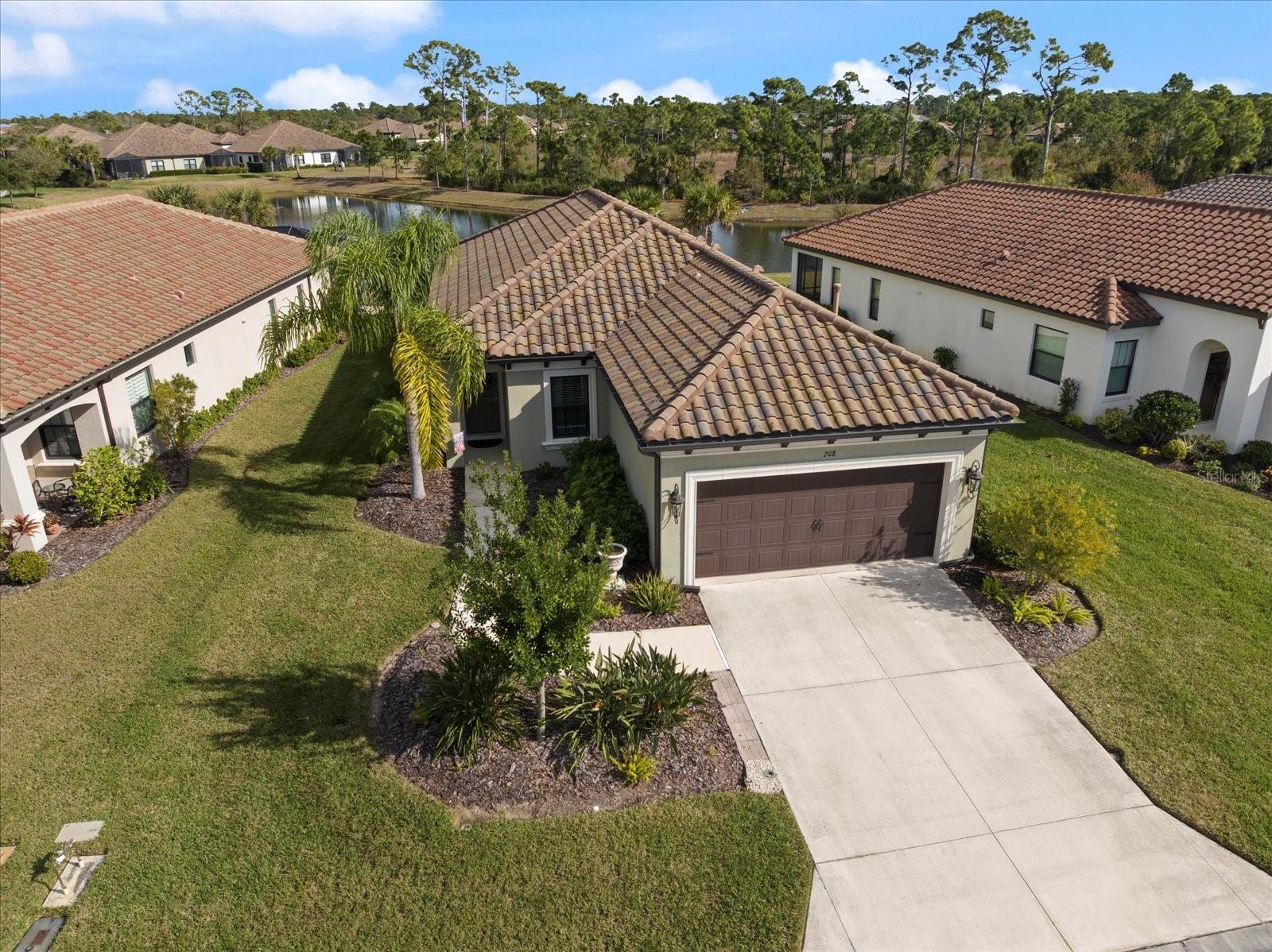 Welcome to Vicenza.  This beautiful Tuscan Model Neal home is full of updates and is situated on one of the most premium home sites in the community.  Just a short walk from the clubhouse and community pool, pickleball and dog park, this beauty enjoys beautiful sunrises over the lake in the backyard.  Built in 2020 this home offers many upgrades including a Radiant Roof Barrier which is a thin layer of aluminum laminated on the roof sheathing, so you stay cooler in the summer and warmer in the winter.  From your large extended lanai, you will enjoy the morning sunrise over the pond and the constant wildlife in the green space behind the lake.  Upgrades include large diagonal tiles throughout the home, wood cabinets, coffer ceiling in the living room, utility sink in the garage, a gas water heater and gas range.  Other features of this home include granite countertops, an open floor plan dual sinks in the master bath and a Roman shower.   The original owner's desire to move closer to family is your opportunity to own this premium piece of Paradise.