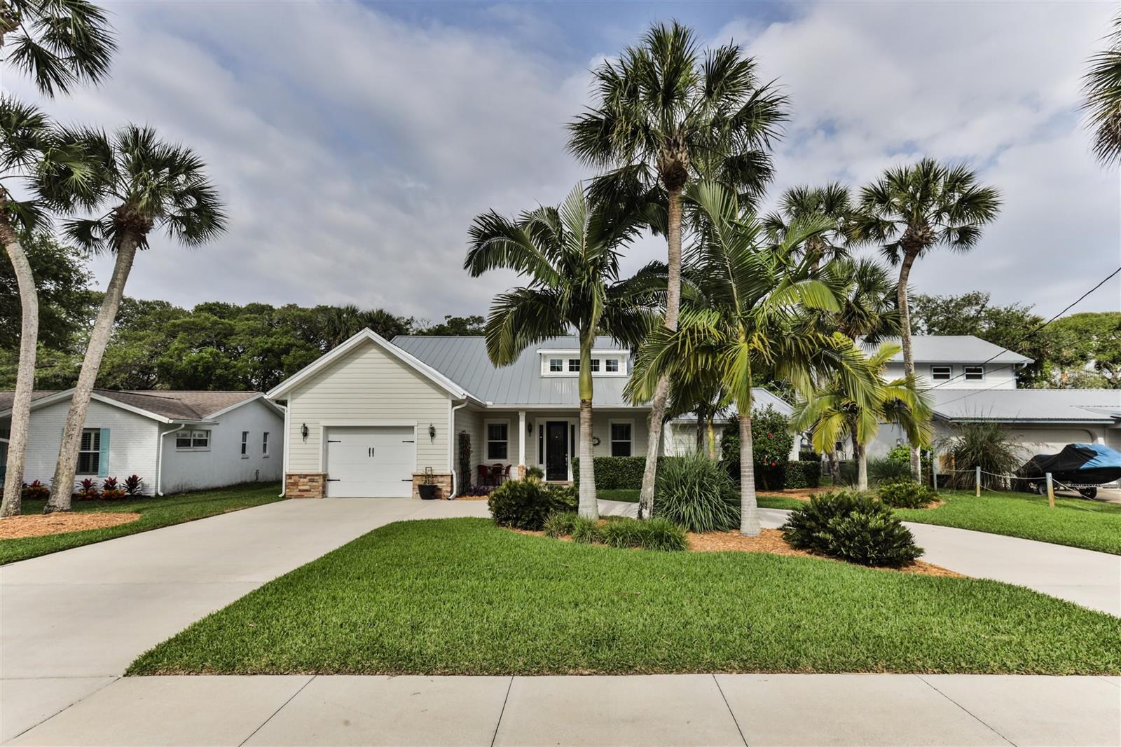 Welcome to your 3 Bedroom 3 Bath home in the highly sought-after Central Beach area of New Smyrna Beach.  Literally walk to NSB’s finest restaurants like the Garlic and Norwoods or bike ride over to the beach.  Live like the locals and golf cart around town to do your shopping.  This large custom renovated home will meet all your Beach Lifestyle needs.  As you drive up you will immediately notice the pride of ownership and curb appeal this home has.  Tropical landscaping and mature palms give you that Island feel.   Fall in love as you enter the large living/dining space with vaulted ceilings, gas fireplace and loads of natural light.  Tasteful ceramic wood like tile throughout the living areas and kitchen.  Gourmet Chefs kitchen offers gas range, tall wood cabinets, large granite bar/island, stylish lighting and walk in pantry.  Enjoy entertaining in the thoughtful open concept kitchen/living/dining space.  Escape to your own sanctuary in your large primary bedroom and gorgeous en-suite bath with custom in laid tile, double vanity and separate step in shower and tub.  Step outside to enjoy your private backyard retreat with spacious patio area and outdoor shower.  Your guests will appreciate the privacy in the 2 nicely sized bedrooms, one with its own attached bath.  You also have a office/flex space which gives you that much more room and privacy. This home is loaded with upgrades like spray foam insulation, Galvalume metal roof, hurricane rated windows, gas tankless hot water heater, plantation shutters to name just a few.  Complete remodel/addition done in 2016.  Indoor laundry room, oversized garage with shelving, irrigation system, the list goes on.   Make your appointment to see this one-of-a-kind home and start “Living the Dream” in NSB today. ;Water: City