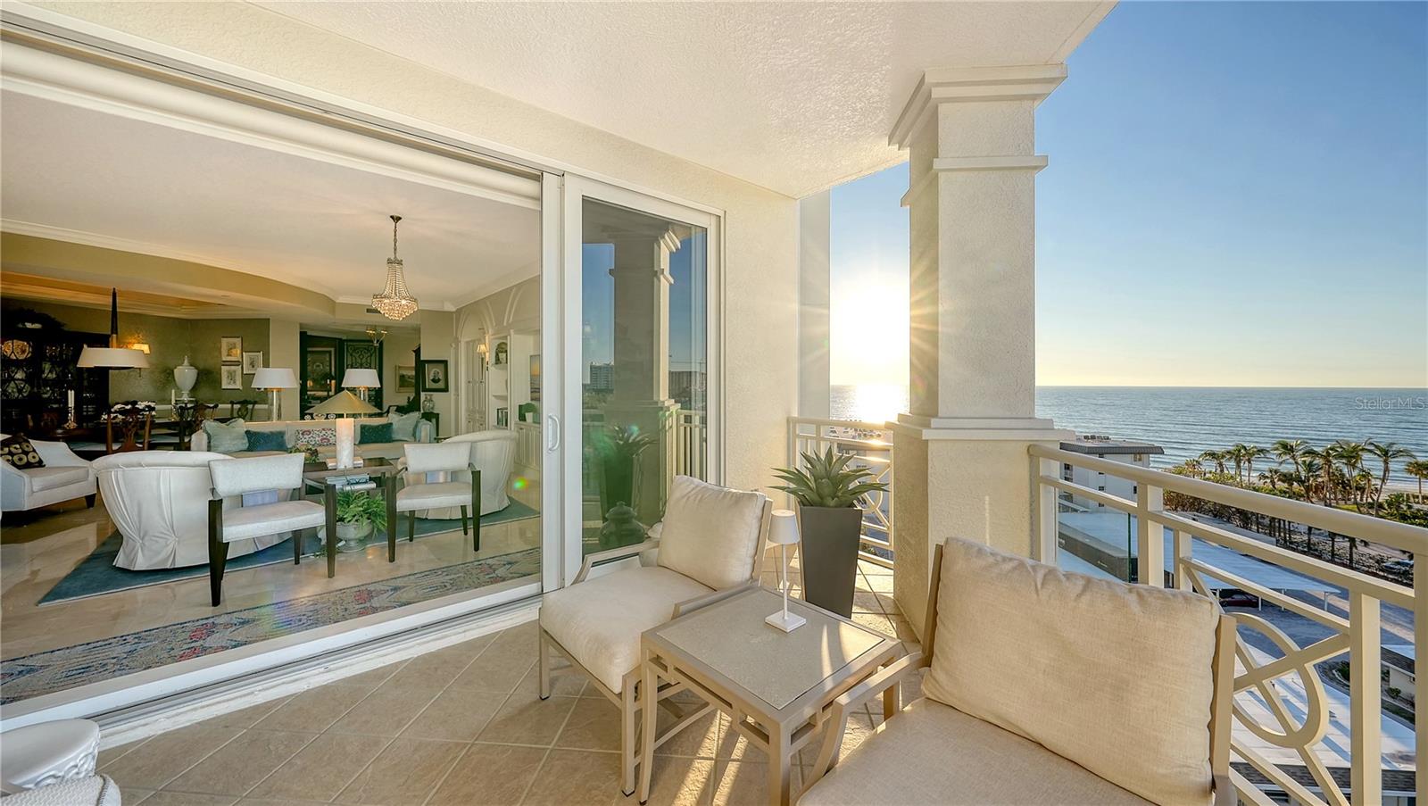 Turnkey furnished executive residence set high on the seventh floor of Orchid Beach Club, this Lido Key beachfront condominium captures sweeping Gulf, bay, and downtown Sarasota views from the moment of arrival. Designed for elevated coastal living, the nearly 3,000-square-foot layout offers three bedrooms, three full baths, private elevator access, and multiple terraces that create a seamless indoor-outdoor lifestyle.

A residents-only elevator opens directly into a private lobby, where double iron filigree doors introduce a refined interior filled with natural light. High cove ceilings with inset lighting, custom millwork, wood paneling, motorized window treatments, and thoughtfully updated finishes establish a polished, modern aesthetic. Walls of impact glass frame unobstructed water and city vistas, enhancing every living space.

The gourmet kitchen blends clean design with functionality, featuring quartz countertops, sleek cabinetry, center island with seating, breakfast bar, and premium Bosch and Dacor appliances, including a six-burner gas range and warming drawer. The kitchen flows effortlessly into the great room and dining area, creating an ideal setting for both entertaining and everyday living.

The Gulf-front primary suite offers a private retreat with terrace access, dual walk-in closets, and a renovated bath featuring marble-inspired finishes, dual vanities, soaking tub, and walk-in shower. Two guest suites are positioned in a split layout for privacy—one with terrace access and the other with its own private balcony—providing comfortable accommodations for visitors.

Three terraces extend the living experience outdoors. The expansive bay-facing terrace features a full summer kitchen with a new (2024) built-in gas grill, generous dining area, and ample seating space for sunset entertaining. A Gulf-facing terrace is shared by the primary suite and third bedroom, while the second guest suite enjoys its own secluded balcony.

Orchid Beach Club is an exclusive Gulf-front community of just 54 residences, offering a full-service lifestyle with 24-hour gated entry, concierge services, and a recently updated clubhouse featuring a social room, catering kitchen, library, billiards, and lounge. The wellness amenities include a fitness center, sauna, spa room, and massage services. Outdoors, the Gulf-side pool and spa are surrounded by a spacious sun deck, with direct access to Lido Beach’s soft sand and turquoise waters.

Ideally located near St. Armands Circle, Longboat Key, and downtown Sarasota, residents enjoy close proximity to fine dining, boutique shopping, marinas, and renowned cultural venues including the Van Wezel Performing Arts Hall, Sarasota Opera House, and The Ringling Museum. This turnkey furnished executive residence offers a rare opportunity to experience beachfront living with exceptional views, privacy, and convenience on Lido Key.