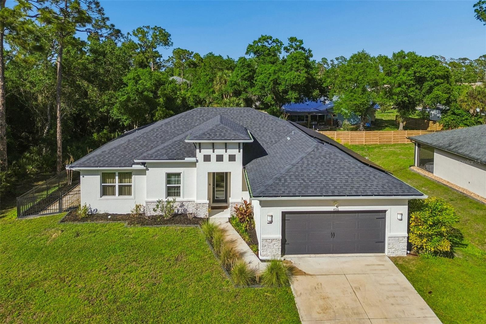 OWNED SOLAR/ZERO ENERGY HOME!! See all the details below!
Spacious Smart Home with Privacy, Upgrades & Energy Efficiency!
Welcome to this beautifully maintained 3-bedroom, 2-bath home with a versatile den/office—perfect for working from home or creating your ideal flex space. Designed with comfort and convenience in mind, this smart home offers modern living in a peaceful setting with no rear neighbors and quiet street. NO HOA and NO CDD fees!
This home has a spacious open floor plan, bonus room, quartz countertops, stainless steel appliances, 42” real wood soft close cabinets, luxury tile plank flooring, 9’4” ceilings with tray ceiling in primary suite, huge walk-in closets, covered lanai, irrigation systems, designer landscaping, water softener system, hurricane panels and a 10 year structural warranty by Maverick.
The home features an oversized two-car garage that is fully insulated and equipped with a portable AC unit—ideal for a workshop, gym, or additional climate-controlled space. Inside, you’ll find thoughtful upgrades including a whole-house water filtration system.
Step outside to enjoy stunning landscape lighting that enhances the property’s curb appeal and ambiance in the evenings. With two storage sheds, you’ll have plenty of room for tools, hobbies, and more. Hurricane shutters provide added peace of mind, while energy-efficient solar panels help keep utility costs low.
Specifically, this is a ZERO ENERGY home (or net 35), meaning that they can produce as much or more energy as they consume depending on your habits. This home comes with a warrantied solar system that is already paid for in full and included in this home’s listing price. This plus cutting-edge energy efficient technology will save you thousands of dollars year over year. Energy Efficient Features: Spray foam insulation in the block wall structure and trusses with double pane windows that create an airtight seal, LED lighting, Energy Star appliances, the most energy efficient water heater on the market, insulated ductwork, high performance 16 SEER HVAC units and more. Standard Features: Savings: You can save approximately $1,986 in utility costs per year or $19,830 over 10 years.  *The annual utility savings listed above is based on our third-party verified HERS rating and the average American household energy consumption. The amount you can save in utility costs with or without solar could be higher or lower depending on how much energy you use in your home.”
Tucked away from the hustle and bustle, yet conveniently located just minutes from shopping, dining and nearby airports, this home truly offers the best of both privacy and accessibility. Why wait for new construction with minimal upgrades when you can have all of this!!
Don’t miss this incredible opportunity—schedule your private showing today!