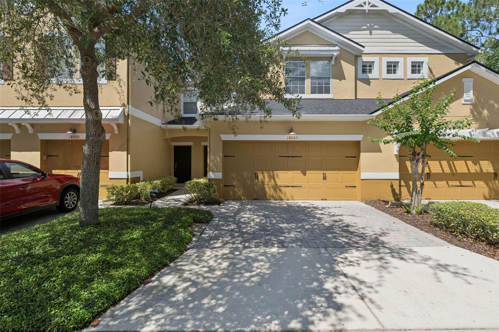 Welcome to resort-style living in the gated community of Oasis Cove in the heart of Windermere! This beautifully maintained three-bedroom, 2.5-bath townhome with a two-car garage also features a spacious loft and a versatile bonus room/home office, offering flexible living space beyond the traditional bedroom layout. Tucked away on a quiet dead-end street with minimal traffic, the home enjoys peaceful wooded and lake views with no rear neighbors, creating a tranquil retreat to come home to each day. Inside, soaring ceilings and an open-concept layout create a bright and spacious feel. The updated kitchen features granite countertops, ample cabinetry and overlooks the main living area, ideal for entertaining or everyday living. The primary suite is conveniently downstairs and offers serene wooded views for a relaxing escape. Upstairs, you’ll find additional bedrooms along with the loft and bonus room, ideal for remote work, hobbies, a media room, playroom or guest overflow space. The laundry room is also conveniently upstairs. Sellers are offering a $5,000 carpet allowance with an acceptable offer, giving buyers the opportunity to personalize the flooring to their taste. Enjoy Florida living year-round from the screened patio and open patio deck, both with attractive stone pavers in the front walkway and rear of the home. Additional upgrades include a 2020 HVAC system with UV lighting and an air filtration system for enhanced comfort and air quality. The home is also wired for surround sound, and the speakers are available should buyers wish to reconnect them after the freshly painted downstairs interior. Residents of Oasis Cove enjoy exceptional amenities, including a resort-style pool with lake views, fitness center, clubhouse, playground and beautifully maintained grounds. HOA fees include exterior maintenance, water, cable, internet, and grounds maintenance for added convenience and value. Just minutes from shopping, dining and everyday conveniences, this home also offers quick access to SR 429, Florida’s Turnpike, and Interstate 4. Enjoy being approximately 20 minutes from Walt Disney World, EPCOT and Disney's Animal Kingdom Theme Park while enjoying the peaceful charm of Windermere living. Nearby attractions also include Hamlin Town Center, golf courses, scenic lakes, restaurants and top-rated schools.