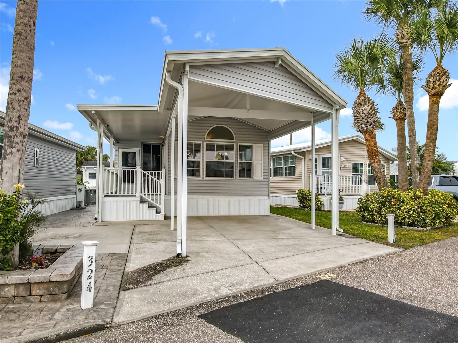 WOW!! Stop the car honey!!  Don't miss out on this wonderful opportunity to acquire an immaculately maintained property just a stones throw from the clubhouse and amenities. The home features a large carport and covered porch at the front while the rear affords a peaceful view of the canal from both the spacious trex deck and the Florida room. This welcoming property benefits from a new roof in 2023, double pane windows, fireplace, smooth top stove, stackable washer/dryer and is being sold fully furnished and equipped as seen. Come and experience the fantastic lifestyle that this unique community offers. NO LOT RENT - YOU OWN THE LAND!! Amenities include 2 heated swimming pools; private access to a 179 acre lake (Lake Davenport); 9 hole golf course; tennis; pickleball; shuffle board; 9 hole putt-putt golf; 8 bath houses scattered throughout the community; laundry facilities; beautiful 2 story clubhouse offering an endless array of entertainment throughout the year. All of this for the low Association Fee of $768 per quarter which also includes Cable TV, Lawn Mowing, Sewer, Trash and Water. UNBELIEVABLE VALUE FOR MONEY - you won't find a more AFFORDABLE LIFESTYLE !!!!  Please remember 55+, no VA or FHA financing, 1 pet rule. The park benefits from close proximity to Disney, medical facilities, restaurants & grocery stores. Don't delay!! Put this home on your 'must see list' and ask to arrange a viewing today.