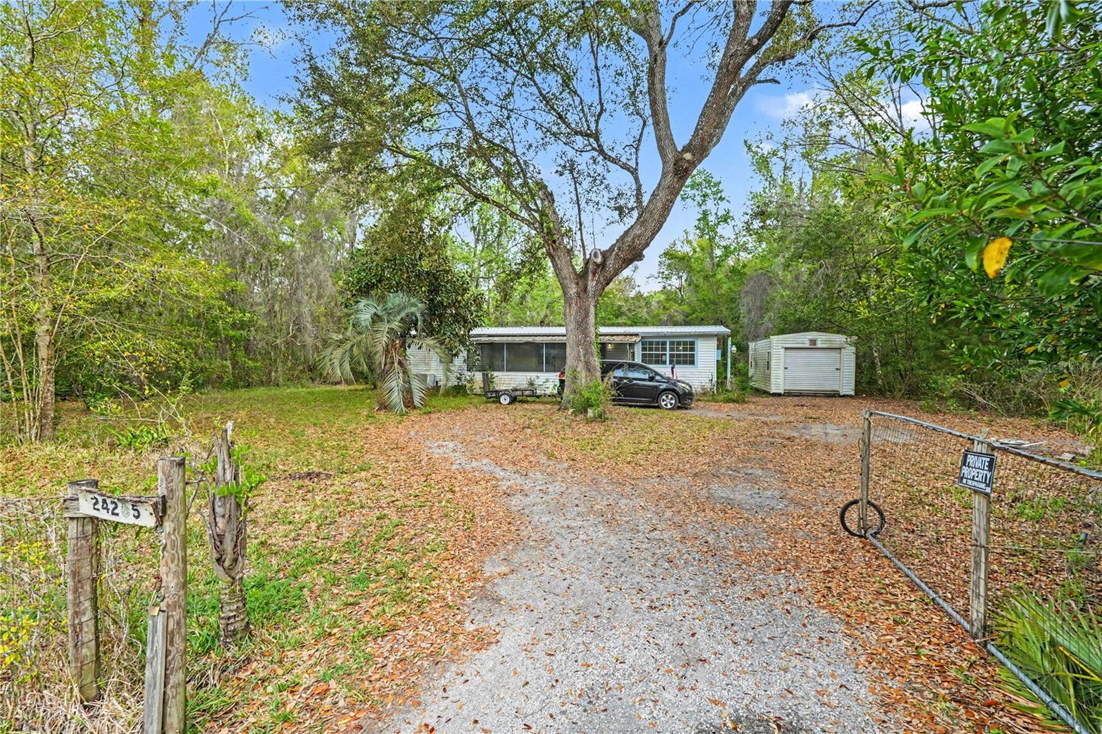 Opportunity awaits in Brooksville! This three-bedroom, two-bathroom mobile home offers 1,334 square feet of living space and sits on nearly 1.5 acres - giving you the space, privacy, and tranquil natural surroundings. Major updates have already been taken care of, including a 2024 roof and a 2021 AC, providing a solid foundation as you bring your own vision to life. Inside, the home features a functional, open floor plan with a comfortable flow between the living area and kitchen, along with a cozy breakfast nook. The primary bedroom includes a dual-sink vanity and a step-in shower, while the second bathroom also offers a glass-enclosed walk-in shower. The additional bedrooms are nicely sized and offer flexibility for guests, a home office, or hobbies. Step outside and enjoy the peaceful setting from your screened front porch - perfect for relaxing and taking in the surrounding nature. The expansive lot offers endless possibilities, whether you’re dreaming of a garden, outdoor entertaining space, or simply enjoying the privacy and room to roam. A separate shed provides extra storage for tools or equipment. This property is ideal for those looking to add their own creative touches and updates while taking advantage of the land, space, and serene environment. If you’ve been searching for a private slice of Florida living with room to grow, this is it!