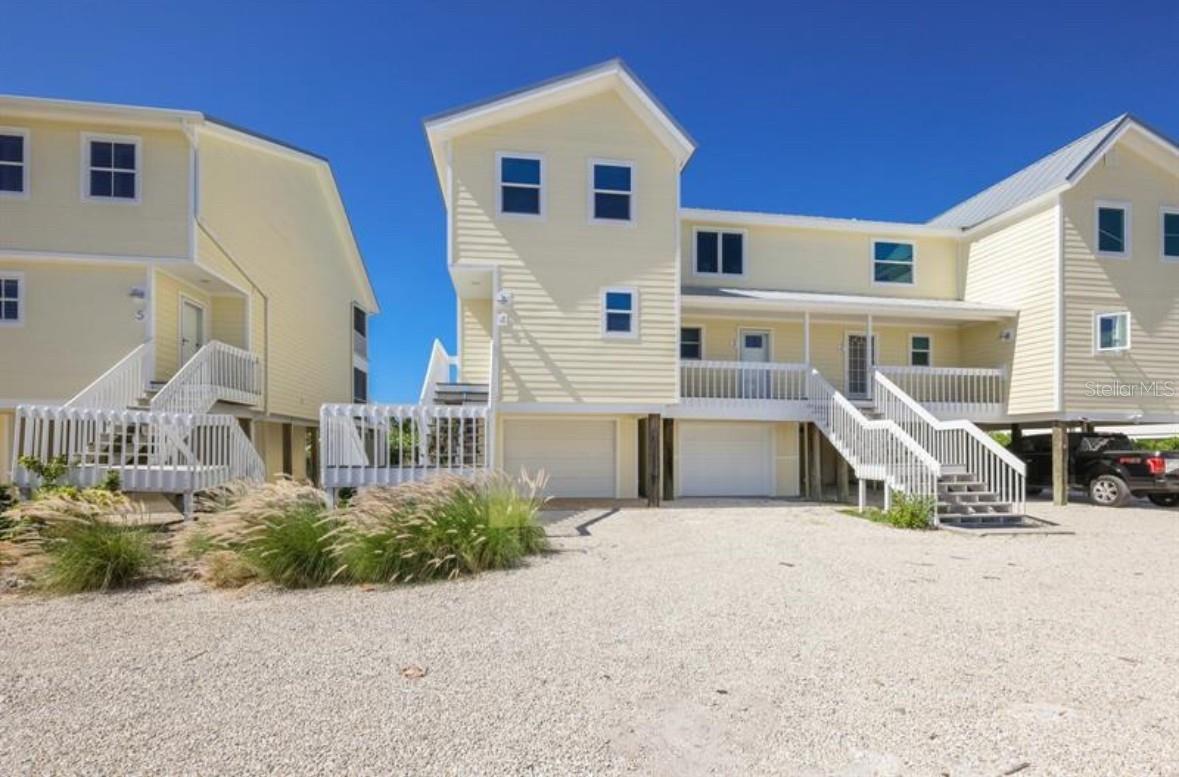 Spectacular Southern exposure corner beach front villa that has been impeccably rebuilt featuring expanded, incredible, open beachfront sunning deck maximizing the Gulf of America sunset views! The main level includes an open and spacious living room, dining area, and all new stainless GE appliances, custom wood cabinetry and beautiful Marble countertops throughout the home. Meticulously crafted wood finishes, plank tile, maintenance free floors throughout, looks exactly like wood. Additional features include; refined wood staircase, cable railing, custom lighting, subway tile backsplash and much more! Gulfside screened porch out to the newly added spacious open deck on the beach! The Southern exposure and Westerly Sunsets are breathtaking. Top floor is comprised of the guest ensuite bedroom and bath, Gulfside Master ensuite bedroom and bath...complete with screened porch and floating Teak deck. The ground level, out of the sun patio features a fully enclosed outdoor shower, all leading to the pristine beach. The newer enclosed garage is air conditioned and offers back of the enclosed space french doors for south side access for the golf cart and a Hurricane Rated garage door for your SUV. The revamped exterior features; 2021 metal roof, impact glass throughout, Trex decking with soffits, trim and composite siding. HOA approved plans to add an ensuite bedroom with modified entry. Excellent rental history if desired. A complete, like new, beautiful Townhome...come and visit this almost completely rebuilt - only 10 home -  beachfront development!