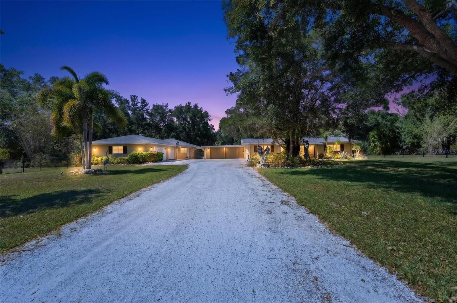 One of Sarasota’s most unique and sought-after acreage communities, DeSoto Acres combines country living with all the city conveniences! No HOA and No CDD makes this a unique choice for freedom.  This stunning county estate is nestled on 2.24 acres of land that’s fully fenced and gated. This private estate features a beautifully updated main residence, a fully equipped guest house, sparkling pool, tranquil pond, fire pit gathering area, oversized workshop shed, and room to truly live the Florida lifestyle. The main home offers over 2,300 square feet of updated living space including a spacious living and dining area overlooking the pool, granite countertops throughout the home, custom cabinetry with pull-out shelving and built-in appliance storage. A convenient breakfast nook area with built-in seating and additional storage. Flexible office/den space that can serve as a fifth bedroom., and an outdoor private shower off of the primary suite which is also accessible to the pool. The guest house is perfect for guests, multigenerational living, rental income, or a private home office. The guest house is approximately 800-square-feet and includes a full kitchen, panty, spacious living room, large bedroom with walk in closet, and full bath. It also features a dedicated laundry room, screened lanai, and its own yard and garden areas. Step outside and enjoy your own private Sarasota retreat including a sparkling pool, scenic pond, fire pit overlooking the water, mature landscaping and a large shed with power. Half of the shed has been converted into a large chicken coop with room for 20+ chickens with its own run. This rare piece of paradise offers room for gardens, animals, RVs, boats, and is ready for your vision. Conveniently located near Sarasota's stunning beaches, SRQ airport, UTC and so much more! Additional Features include- • Fully fenced and gated 2.24 acres • Two separate gated entrances • 3-car side-entry garage • 2-car carport • Pull-through garage bay • Wind-rated garage doors • Two HVAC systems • Well with newer pump • Water softener, filtration, and aerator systems • Tankless water heaters • Workshop with dog wash station • X Flood Zone The neighborhood’s historic agricultural overlay allows horses, chickens, roosters, and many other farm animals while remaining just minutes from shopping, dining, medical facilities, downtown Sarasota, University Town Center, and Gulf Coast beaches. Rarely does a property offer this much land, flexibility, privacy, and value this close to everything Sarasota has to offer! Whether you’re seeking multigenerational living, a private retreat, space for a home-based business, hobby farm, or simply room to breathe, this property delivers opportunities that are increasingly difficult to find in Sarasota.