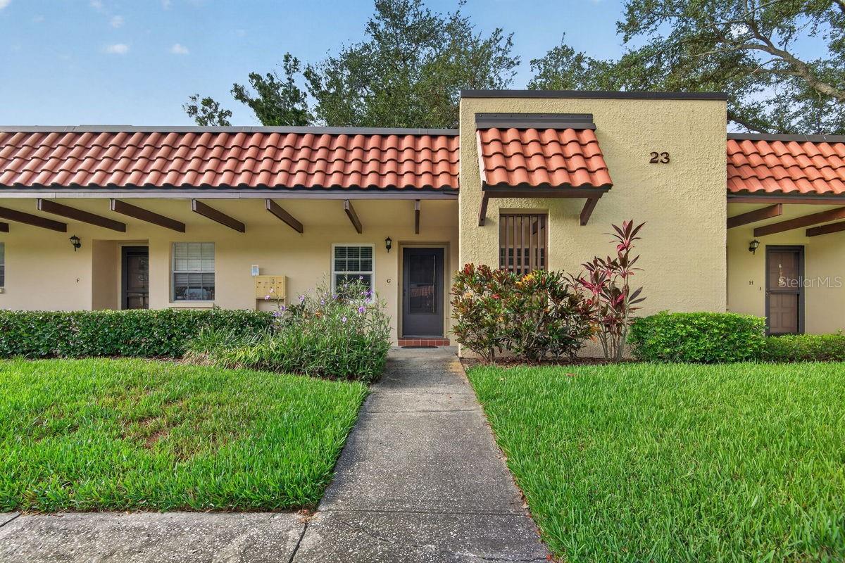 Looking for an affordable, move-in ready, 2BR villa in a sought-after 55+ community? Look no further! This villa is hidden away off the beaten path on a quiet street with sparse traffic, yet near everything. It sits on high ground in a NON-flood zone. It comes furnished and offers a bright, open, split bedroom plan that includes the following: covered entry, welcoming foyer, living/dining room combo, kitchen with pass thru, master bedroom with built-in & walk-in closets plus separate bathroom access, office or guest bedroom, hall bath, utility closet with washer & dryer, plus a sunroom PERFECT for your morning coffee and evening glass of wine. Updates include, KITCHEN: cabinets with hardware, counters with 4" backsplash, sink, faucet, and appliances, BATHROOM: vanity, faucet, mirrors, toilet, extra cabinet, showerhead, and built-in shower enclosure, INTERIOR: wood laminate and bamboo flooring, double-paned impact windows, sun and window shades, crown molding, water heater (2023), A/C system (2025), electrical box (2026), and fresh paint. Unit also comes with a carport footsteps from the front door. Pinehurst Village is a meticulously maintained community with mature trees, tropical plants, and lush green lawns. It features a community heated pool, shuffleboard, picnic area with grills, and clubhouse with active social calendar. It is ideally located a short drive from supermarkets, banks, major shopping hubs, Countryside Mall, Honeymoon Island, and Historic Downtown Dunedin, with its unique shops, top rated restaurants and endless activities. Enjoy countless amenities the area offers: beaches, parks, casual & fine dining, roof top bars, micro-breweries, cafes, bike riding, boating, fishing, downtown festivals, concerts, art shows, spring training baseball, championship golf, sunsets, and events at the Community & Fine Art Centers. This is a Must See for buyers seeking a move-in ready, maintenance free villa with an active & vibrant lifestyle.