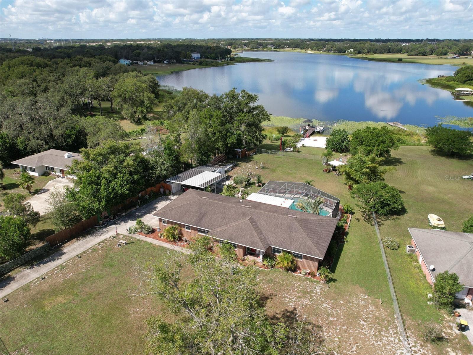 Charming LAKEFRONT home on over an acre of land in Central Florida! Enjoy the views of Lake Deeson from multiple spaces in this well loved home. This spacious home features 3 bedrooms and 3 full bathrooms, a large and refreshing pool, green house, multiple fruit trees, chicken coop, boat dock with seating area and your very own BEACH!!!! Entire property is fully fenced. It checks all the boxes! This is the perfect home to enjoy your privacy as well as entertain your guests at your leisure. Lounge by the pool or jump on the boat to enjoy some fishing and/or skiing! Plenty of room for parking and storage for all of your toys. Conveniently located to shopping as well as I4. Situated right between Tampa and Orlando, the best of both worlds! Your new home awaits you!