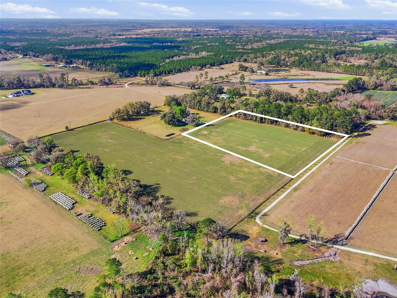 Discover a rare opportunity to own 5+ acres in beautiful Alachua, Florida, offering the perfect canvas for your forever home. Located in a peaceful farm community in North Florida, this high-and-dry, Agricultural-zoned property is thoughtfully cleared and ready for your vision. With no HOA and no deed restrictions, you’ll enjoy the flexibility and freedom to build exactly what you’ve been dreaming of. Privately tucked away for peace and seclusion, this spacious property provides the ideal setting for a custom home, small farm, homestead, or private country retreat. Surrounded by the natural beauty and quiet charm of Alachua, the property offers the tranquility of rural living while remaining conveniently close to modern amenities. Looking for even more space? Three additional adjoining parcels are also available, giving buyers the unique opportunity to purchase all four parcels together for over 20 acres, creating a private estate, family compound, or expansive farm. Enjoy the best of both worlds — serene country living just minutes from the Santa Fe River, I-75, nearby shopping, medical facilities, and an easy commute to Gainesville for work, dining, and entertainment. Opportunities like this are becoming increasingly rare — combining acreage, versatility, privacy, and convenience in one exceptional North Florida offering. Build the sanctuary you’ve always envisioned and experience the charm and tranquility that make Alachua such a special place to call home.