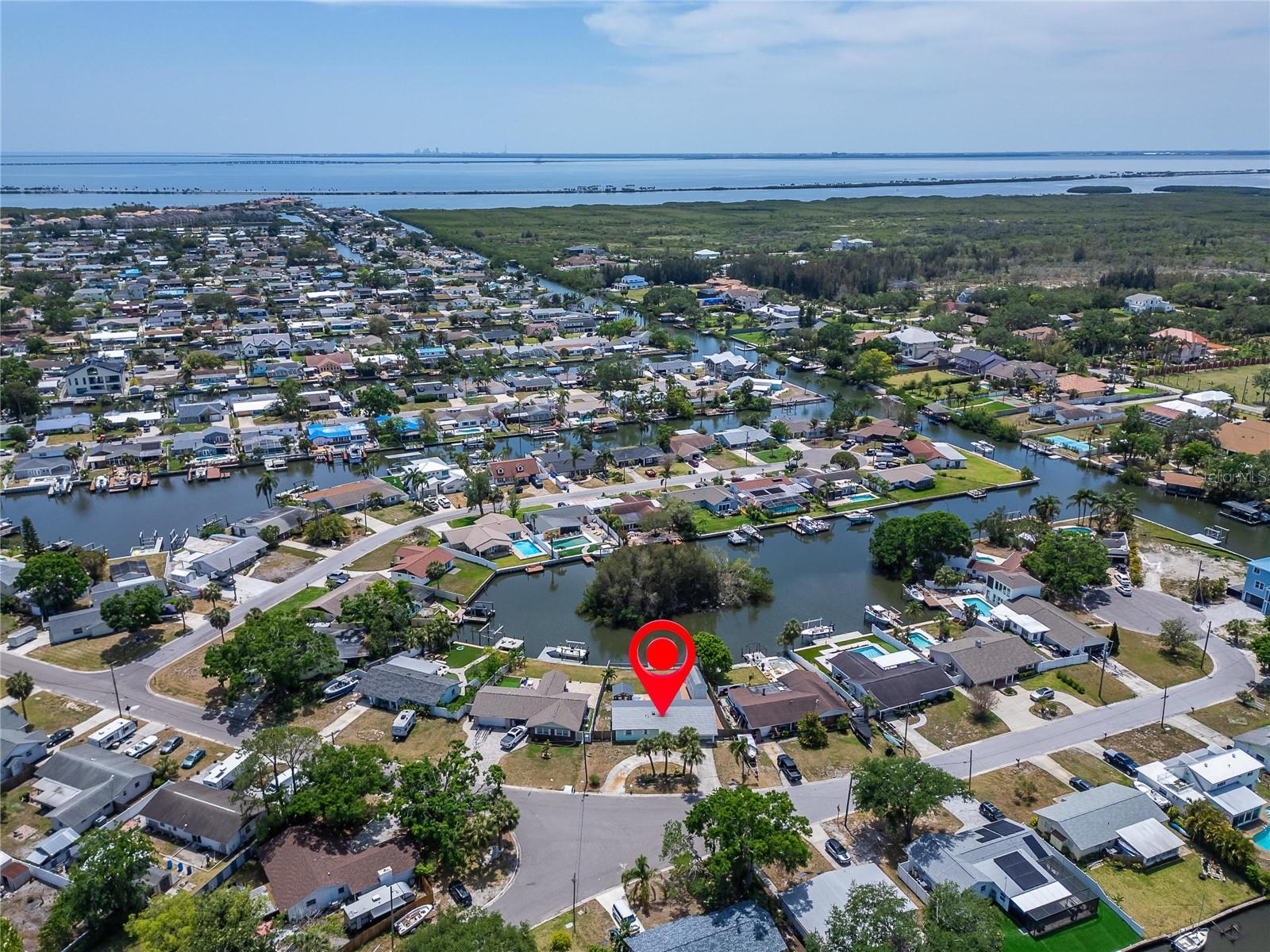 Virtually Staged. Virtually Staged — Discover this immaculate WATERFRONT home offering breathtaking views in the highly sought-after boating community of Bay Crest Park! This MOVE-IN READY residence impresses from the moment you arrive, featuring bright, open living spaces and NO CDD or HOA fees.

Step into your brand-new 2025 kitchen, showcasing stunning countertops, new appliances, and elegant soft-close cabinetry. The open floor plan includes 3 bedrooms, 2 bathrooms, a spacious family room, and a dedicated dining area—perfect for both everyday living and entertaining.

Beautiful travertine flooring flows throughout the main living areas, while the bedrooms feature classic terrazzo floors. Recessed lighting adds a modern touch throughout the home. The expansive primary suite offers a walk-in closet with plenty of room for a sitting area. The updated primary bath features a sleek double vanity, and the guest bath is enhanced with a natural light–filled skylight.

Additional Highlights:  
Metal roof, whole-home water softener, oversized solar-powered shed, electric-powered gazebo, upgraded pavers, and a spacious screened-in lanai.

Step outside and embrace true Florida living from your private oasis—an oversized covered lanai overlooking your extra-large backyard and tranquil waterfront setting.