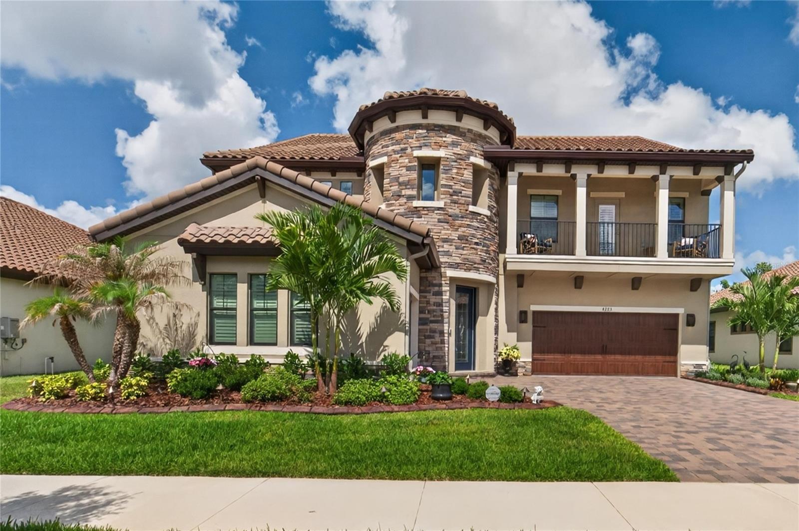 3 Years NEW! Experience luxury without the wait in this stunning West Bay Madeira III located in the gated community of Sanctuary. This better-than-new construction home offers 5 bedrooms, 4.5 bathrooms, a 3-car garage, and a spectacular saltwater pool and spa package on a premium conservation lot with no visible rear neighbors—all move-in ready so you can skip the lengthy build process and start enjoying the Florida lifestyle immediately. Featuring elegant tile roofs, brick paver driveways, and exceptional curb appeal, the Madeira III impresses from the moment you arrive with split garages and a dramatic 2-story rotunda entry accented by a grand open staircase.No detail was overlooked inside this professionally designed home featuring high-end finishes throughout including upgraded cabinetry, quartz countertops, wood-look tile flooring, and upscale designer touches. The breathtaking 2-story foyer opens to both the den and formal dining room before leading into the spacious island kitchen and expansive grand room where oversized sliding glass doors frame incredible views of the resort-style saltwater pool.The first floor offers flexible living with a private guest suite or game room option along with 1.5 bathrooms. Upstairs, the luxurious owner’s retreat features oversized closets and a spa-inspired bath, while 3 additional oversized secondary bedrooms, a large bonus room, private balcony, abundant storage, and conveniently located laundry room complete the second level.Step outside to your extended lanai designed for year-round Florida living, complete with an outdoor kitchen and a luxurious heated saltwater spa-pool featuring color LED lighting, therapy jets, swim-out bench, and expansive entertaining space. The current owner has invested over $150,000 in premium aftermarket upgrades including a WHOLE-HOUSE GENERATOR, gutters, crown molding, custom woodwork, wainscoting, plantation shutters, laundry room cabinetry, and countless additional enhancements that elevate this home far beyond standard new construction.HOA fees are $846 quarterly and there is NO CDD fee, making this exceptional property even more desirable. Why wait to build when your dream WestBay Home is available now? Call today to schedule your private showing and experience the difference for yourself.