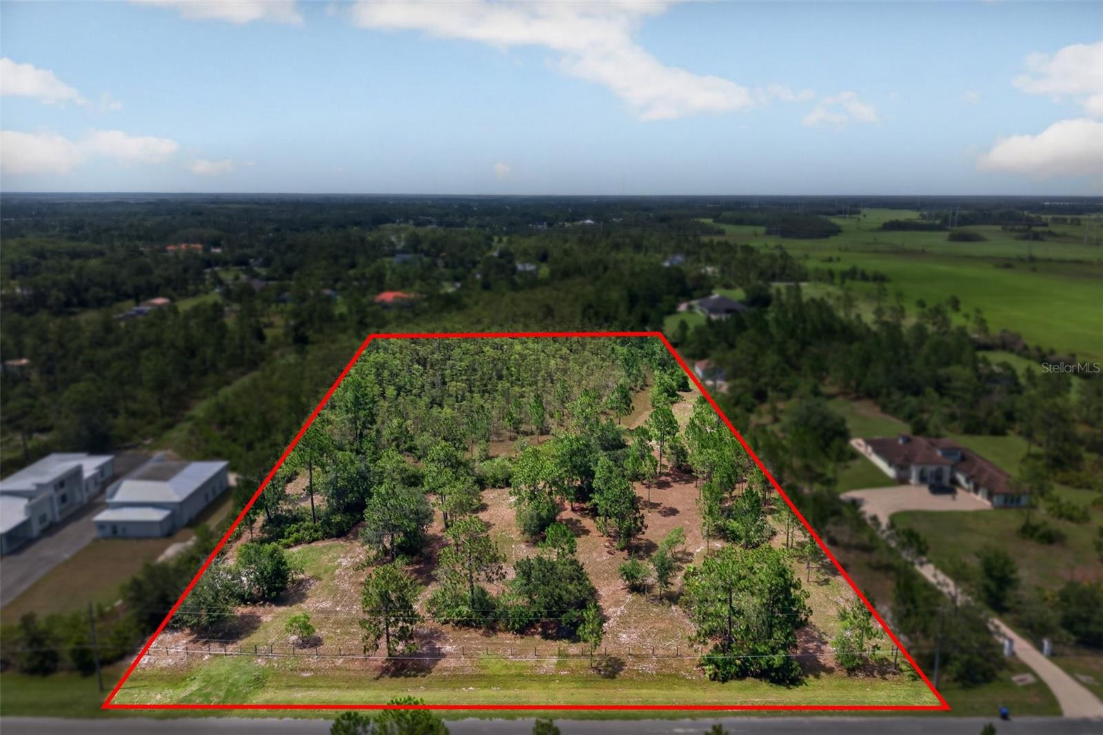 An exceptional opportunity to own a premier 4.51-acre estate homesite adjacent to one of Wedgefield's finest luxury estates. Offering more than 2 acres of high-and-dry, buildable land ideally positioned at the front of the property, this exceptional parcel provides the perfect setting to build your dream home with no mitigation required. The thoughtful layout allows for a straightforward building process while preserving the privacy and natural beauty that define Wedgefield's sought-after acreage lifestyle.

The property is fully fenced and gated, providing added privacy, security, and a welcoming sense of arrival while allowing you to immediately enjoy the land as you begin planning your custom estate.

Whether you envision a luxury residence, detached guest house, expansive workshop, equestrian property, or simply the freedom that comes with owning acreage, this homesite offers endless possibilities. With no HOA restrictions and ample space for recreational vehicles, boats, hobbies, and future expansion, you can design the lifestyle you've always imagined.  A list of well-qualified, custom home builders is available upon request.

For buyers seeking an even more extraordinary opportunity, the adjacent custom luxury estate situated on 3.52 acres, with no wetlands, is also available for purchase under MLS #O6424407 (20927 Quarterly Parkway). Together, these two properties create a rare opportunity to own more than 8 acres of contiguous land, making it ideal for a multigenerational family compound, private retreat, or one of the most impressive estate properties in East Orlando.

Located on a quiet dead-end street in the desirable Wedgefield community.  With A-rated schools, community parks and preserves and an 18-hole golf course, you'll enjoy the tranquility of nature while remaining just 30 minutes from Orlando International Airport, Downtown Orlando, Port Canaveral, Florida's beautiful east coast beaches, and Orlando's world-renowned attractions.  You don't have to sacrifice convenience for privacy.

Whether purchased independently or combined with the adjoining 3.52-acre luxury estate, this premier estate homesite offers an exceptional opportunity to create a legacy property in one of East Orlando's most desirable acreage communities.