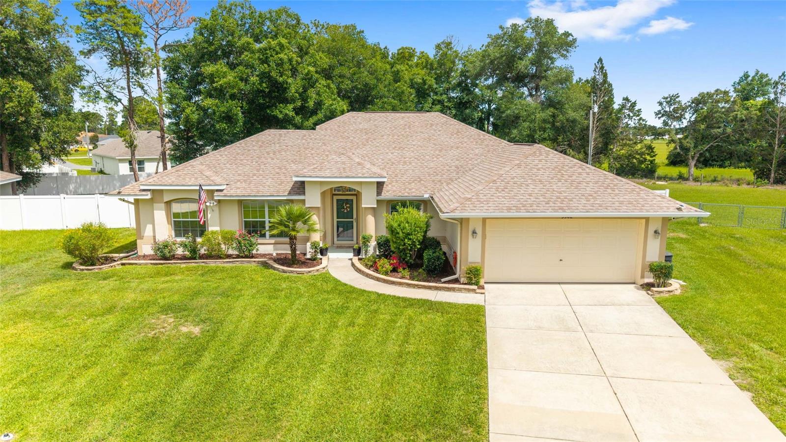 Step into this beautifully maintained SOLAR-HEATED POOL HOME where thoughtful upgrades and timeless design come together to create a truly elevated living experience. Set on a LARGE almost half-acre FENCED LOT with mature landscaping, stacked-stone beds, and a 2022 ROOF, this residence offers both privacy and curb appeal from the moment you arrive. A charming COVERED FRONT PORCH with columns and a STORM DOOR welcomes you inside to soaring VAULTED CEILINGS, an AUTOMATIC SOLAR TUBE, and an OPEN concept, LIGHT-FILLED FLOOR PLAN designed for effortless living.
The gourmet-inspired kitchen features RAISED-PANEL CABINETRY with CROWN MOLDING, STAINLESS STEEL APPLIANCES, a PANTRY CLOSET, BREAKFAST BAR OVERHANG, and a cozy BREAKFAST NOOK overlooking the pool. Enjoy both FORMAL DINING and a versatile OFFICE/DEN, plus an INSIDE LAUNDRY ROOM with built-in cabinetry for added convenience.

Your private retreat awaits in the spacious PRIMARY SUITE with an En-Suite Bathroom offering DUAL SINKS, a STEP-DOWN TILED SHOWER with glass door, a separate SOAKING TUB with tile surround and PRIVACY WINDOW, a PRIVATE PRIVY, and a generous WALK-IN CLOSET. The guest bath includes a single vanity and is perfectly positioned for visitors.

Outdoor living shines with a COVERED LANAI featuring a ceiling fan and lighting, opening to a SPACIOUS BIRDCAGE that surrounds your SOLAR-HEATED IN-GROUND POOL complete with a RAISED CORNER PLANTER and WATERFALL. A FRENCH DRAIN and VINYL PRIVACY FENCE enhance functionality and peace of mind.

Additional highlights include: HVAC 2019, ADT SECURITY SYSTEM, FULL-HOUSE UV AIR PURIFICATION SYSTEM, 2-CAR GARAGE with overhead lighting and shelving, and mature landscaping that frames the home beautifully.

This is more than a home — it’s a PRIVATE OASIS designed for comfort, style, and effortless Florida living.