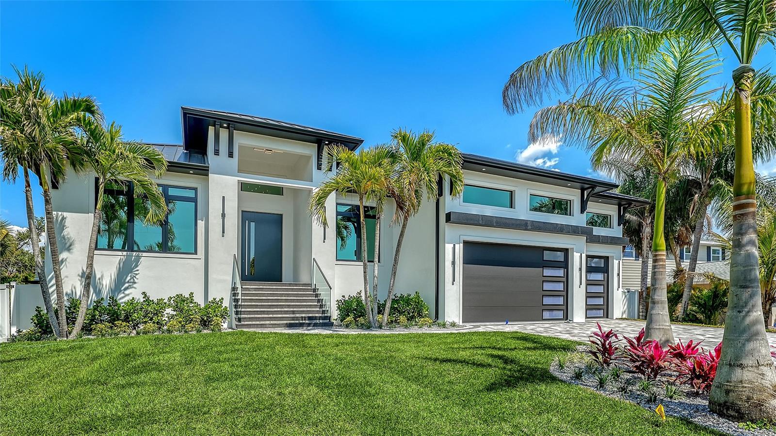 Experience the pinnacle of coastal luxury in this newly constructed masterpiece, ideally located just moments from the beach and a short walk to the vibrant shops, dining, and entertainment of Siesta Village. Situated on an oversized lot, this exceptional property offers added privacy, space, and presence rarely found in this sought-after location. Featuring 4 bedrooms, a private office, and 4.5 bathrooms, the home blends modern elegance with thoughtful design at every turn.
A striking first impression begins at the grand entry, where sleek modern pivot doors set the tone for the refined finishes found throughout. Inside, soaring ceilings and expansive living spaces are filled with natural light, while oversized sliding glass doors create a seamless connection between indoor and outdoor living.
The chef’s kitchen is a true centerpiece, showcasing custom flat-panel cabinetry, premium Thermador appliances, and a hidden entrance to a spacious walk-in pantry—offering both style and function. Every detail has been carefully curated, from custom built-ins in select bedrooms to the high-end finishes that create an atmosphere of refined comfort.
The main living spaces open effortlessly to a private outdoor retreat featuring a resort-style pool and spa, sun shelf, and panoramic screened enclosure with elegant glass railings—perfect for entertaining or relaxing in complete privacy.
Car enthusiasts and those in need of extra storage will appreciate the impressive three-car garage with 17-foot ceilings and a built-in car lift, allowing space for a fourth vehicle or additional elevated storage—an exceptional and rare amenity.
Designed with both luxury and resilience in mind, this home offers peace of mind in any season. Built elevated and engineered for coastal living, it is equipped with a buried 500-gallon propane tank and a whole-house generator—providing reliable, uninterrupted power during outages. Combined with modern construction standards and durable materials, this residence delivers a level of security and preparedness rarely found in homes this close to the water.
Complete with integrated smart home features including a whole-home speaker system and security cameras, this residence offers the very best of modern coastal living.
More than just a home, this is a lifestyle opportunity in one of Siesta Key’s most sought-after locations—where luxury meets lasting peace of mind.