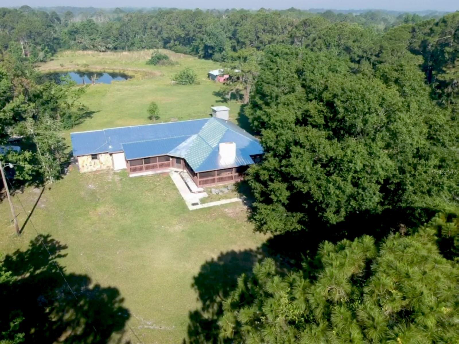 *REDUCED* NEW 4-POINT INSPECTION AVAILABLE UPON REQUEST! Seller IS MOTIVATED! WOW!! GORGEOUS 4 BEDROOM 2 BATH HOME ON SIX ACRES! LARGE MODERN ADDITION DONE IN 1997! WITH MORE RECENT UPDATES SUCH AS THE NEWLY REMODELED KITCHEN AND BATHROOMS! FRESHLY PAINTED INSIDE AND OUT! THIS MOVE-IN READY, HOME CHECKS ALL OF THE BOXES! FIREPLACE! VIEW! PRIVACY! LAND! CLOSE TO TOWN, THE BEACH AND THE INDIAN RIVER WITH NO HOA! Most of this home is a large modern addition completed in 1997 with RECENT BEAUTIFUL, MODERN BATHROOM, KITCHEN, HOME UPDATES. So many possibilities with this home.  The owners remodeled for themselves. THIS IS NOT A FLIP.  The views are gorgeous. The views from almost every room are lush natural Florida.  It's perfect for entertaining large family and friend gatherings! Or just RELAXING on the beautiful front wrap screened porch, swinging on the porch swings while watching the sunrise. The Front porch is huge, there are so many possibilities to enjoy the outdoors.  View the breathtaking sunset from the dining area with a panoramic view or relax on the screened back porch for a spectacular view of the sunsets, vast greenspace and beautiful tree line this property home offers. View the beautiful sunrises, sunsets and listen to the birds and peace that nature brings to this home with its lush setting! It is tucked away near the end of a quiet dead end road, on 6 acres of land. Two A/C units in 2020. New hot water tank 2020. Water purification system 2020. This home and property will make your short list!  This one-of-a-kind property is rare and hard to find. The large, stocked pond and towering oaks just can't be duplicated in today's cookie cutter crowded subdivisions. The home is high and dry with no flooding during recent storms. Home is located in Flood Zone X, flood insurance not required by lenders. Home is ready for you to call home. Agricultural zoning, lots of possibilities, horses and farm animals allowed! Close to boat launches, parks, shopping, dining. Only 10 minutes to New Smyrna Beach, 20 minutes to Space Coast, 45 minutes to Orlando.