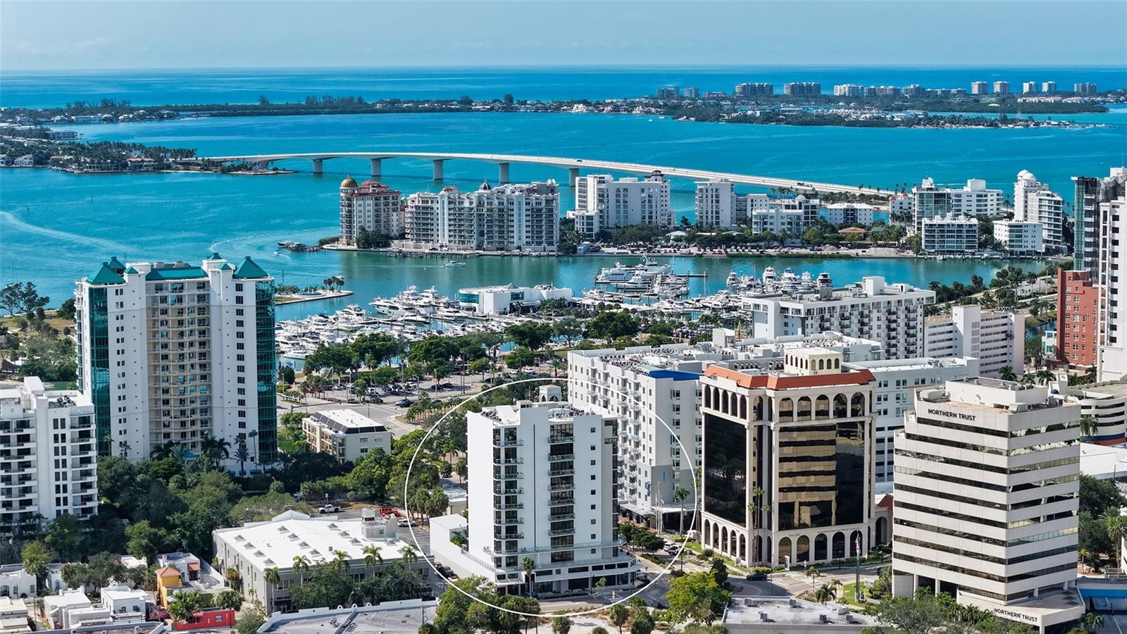 Boutique downtown living takes on a new level of sophistication at Sansara, an exclusive 10-story building with only 17 private residences in one of Sarasota’s most walkable and vibrant locations. Just moments from Burns Court’s cafés, eclectic boutiques, galleries, and the Sarasota Bayfront, this address offers both convenience and a sense of quiet retreat. Residence 302 captures a peaceful, elevated perspective with views of tropical greenery, the glistening pool, and the city skyline beyond. Encompassing nearly 2,300 SF, the home is thoughtfully designed with expansive walls of glass that invite in abundant natural light, rich hardwood flooring, tailored cabinetry, elevated lighting selections, and automated window treatments. The kitchen serves as a stylish centerpiece, appointed with sleek European cabinetry, quartz countertops, premium Bosch appliances plus wine refrigerator, and a spacious island ideal for gathering. The open-concept living area extends effortlessly to a private terrace; an inviting space to start the day or relax in the evening while overlooking the pool below. A well-designed split floor plan provides both comfort and privacy. The primary suite is a serene escape with terrace access, custom walk-in closet, and a spa-like bath featuring dual vanities and a walk-in shower. Two additional guest suites, one perfectly suited for a home office or den, offer versatility for a variety of lifestyles. Additional highlights include impact-rated windows and 10-foot disappearing sliders, multiple outdoor spaces, custom dry bar for effortless entertaining, generously sized laundry room with storage, customized closets, and secure elevator access. Residents of Sansara enjoy a collection of boutique amenities, including a heated saltwater pool and spa, cabana areas, fire pit lounge, outdoor kitchen and grill, a fitness studio, and secure building access. All designed to complement a relaxed yet refined downtown lifestyle. The residence is offered with the option to be sold partially furnished.