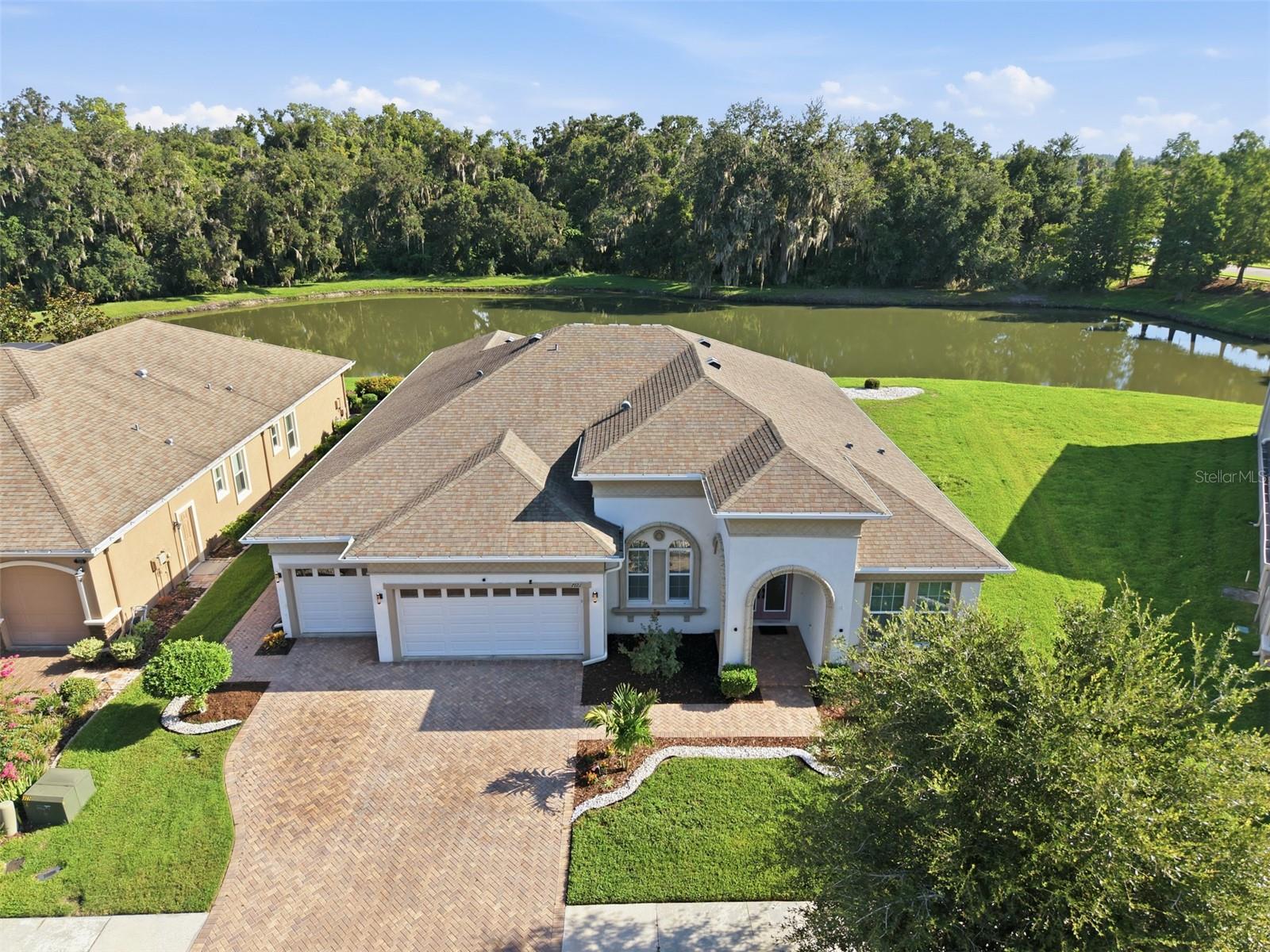 Luxury Living Meets Everyday Comfort in One of Wesley Chapel's Most Desirable Gated Communities!

Welcome to an exceptional residence where timeless elegance, thoughtful design, and breathtaking pond and conservation views create the perfect place to call home. Situated on a premium homesite with no rear neighbors, this meticulously maintained 4-bedroom, 3-bath home with a dedicated office, spacious bonus room, and 3-car garage offers over 3,100 square feet of refined living designed for both entertaining and everyday enjoyment.

From the moment you enter through the impressive double glass doors, soaring ceilings, expansive ceramic tile flooring, crown molding, and abundant natural light create an unforgettable first impression. The heart of the home is the stunning chef's kitchen, featuring an oversized granite island, rich wood cabinetry, stainless steel appliances, built-in oven and microwave, generous storage, and an open design that flows seamlessly into the spacious family room and dining area.

Open the wall of sliding glass doors and step onto the expansive screened lanai where peaceful mornings begin with coffee overlooking the water and evenings end with spectacular sunsets reflecting across the tranquil pond. Surrounded by lush conservation, you'll enjoy exceptional privacy while listening to the sounds of nature just beyond your backyard.

The luxurious primary suite serves as a private retreat with serene water views, while the spa-inspired bath offers dual vanities, a soaking tub, oversized walk-in shower, and generous walk-in closets. Three additional bedrooms, a private office, and an oversized flex room provide endless possibilities for guests, multi-generational living, a home gym, media room, or additional workspace.

Additional highlights include a beautifully appointed laundry room with extensive cabinetry and utility sink, paver driveway and lanai, tile flooring throughout the home, and a split-bedroom floor plan designed for comfort and functionality.

Conveniently located just minutes from Tampa Premium Outlets, The Shops at Wiregrass, KRATE at The Grove, top-rated golf courses, exceptional dining, hospitals, I-75, and everything Wesley Chapel has become known for, this home offers luxury living with unmatched convenience.

Experience the lifestyle you've been waiting for. Schedule your private showing today and discover why this is more than a home, it's your next chapter.