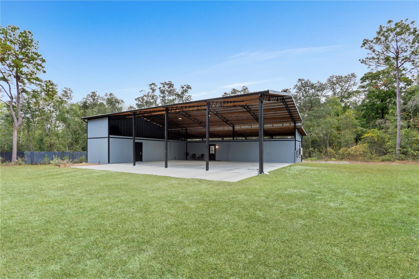 This 9.61-acre property partly cleared is perfect for those looking for a getaway in the country, to park your RV while building a site-built home or while getting ready to put an MH on it, if the county allows. The 2022 pole barn is 60x54 (3240 sq ft) with 2x6 & 6x6 poles, the patio is 12x60, the approach is 12x48, The 1Br/1.5BA with, laundry room, and kitchen. The "barn-dominium" features 4 big bays for parking with a storage room (34x12) with a barn door, ramp, loft access & 1/2 bath access into the house, the concrete pad is set up for a 3rd way-reinforced lift. 650 feet Lime rock driveway with gate, 400 AMP electric service, RV hook up with 50 AMP, 2022 Metal roof, Kitchen features all new appliances with refrigerator, conventional/air fry cooktop oven, microwave, dishwasher, pantry & solid wood kitchen table & stools, butcher block counters with plenty of cabinets. The home features fans in the living room & bedroom, cellular shades, recess lighting throughout, exhaust fan in both bathrooms with a built-in heater & integrated led lights, 3 mini splits (laundry room, living room & bedroom) large laundry room/office with its own mini split, sink, washer & dryer. Double Pane windows throughout the home and the porch features an outside shower, outside lighting & outlets. NO HOA OR DEED RESTRICTIONS.