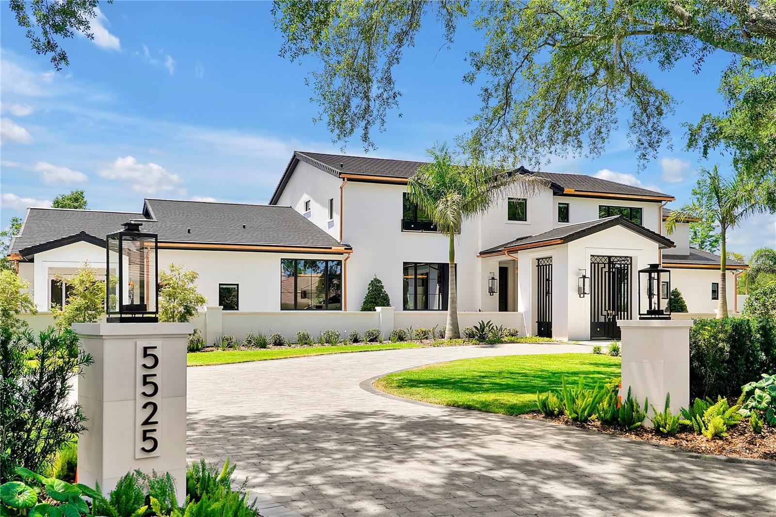 One or more photo(s) has been virtually staged. Exceptional in both style and scale, this extraordinary Isleworth estate represents the pinnacle of luxury living in one of the finest golf club communities in the world. Designed by architect Terry Irwin and built by Ballard Construction, with interior designs by Faith Fournet, the property has been fully transformed and thoughtfully curated over the last three years to deliver exceptional comfort, sophistication and panache at every turn.  The two-story estate is set on a pristine 1.02-acre golf-front home site along Isleworth's famed championship golf course and from the moment you enter, you'll be captivated by the artistry in design and modern innovation. The interiors span more than 9,500 square feet living and 13,000 under roof, blending 5 bedrooms, 5.5 baths and an array of indoor and outdoor living areas with uncompromisingly luxurious finishes designed for effortless entertaining and quiet moments alike. At the heart of the home, the showstopping glass-enclosed wine room—temperature-controlled and with more than 2,200-bottle capacity—is a collector's dream and the ultimate conversation piece.  The primary suite is a sanctuary unto itself, featuring a magnificent two-story closet and dedicated dressing room with a bar. Indulge in true tranquility within the home’s private wellness suite, complete with exercise room, a rejuvenating steam room, dry sauna and invigorating cold plunge tub.  Additional interior highlights include the grand kitchen with Cristallo quartzite lighted countertops; a fully custom lounge with full bar; an upper-level game room with bar; an oversized, air-conditioned garage accommodating up to 8 vehicles; two laundry rooms; and more.  Outdoor spaces are equally impressive, with an expansive lanai and balcony, a custom swimming pool with fire pits, meticulously landscaped yard adorned with integrated lighting, sound and lush, native greenery and putting green —all overlooking panoramic views of Isleworth’s championship golf course. Whether hosting guests or enjoying a peaceful evening at home, this estate offers a rare opportunity to live a life of unmatched beauty, comfort, and distinction in one of Central Florida's most desirable enclaves.