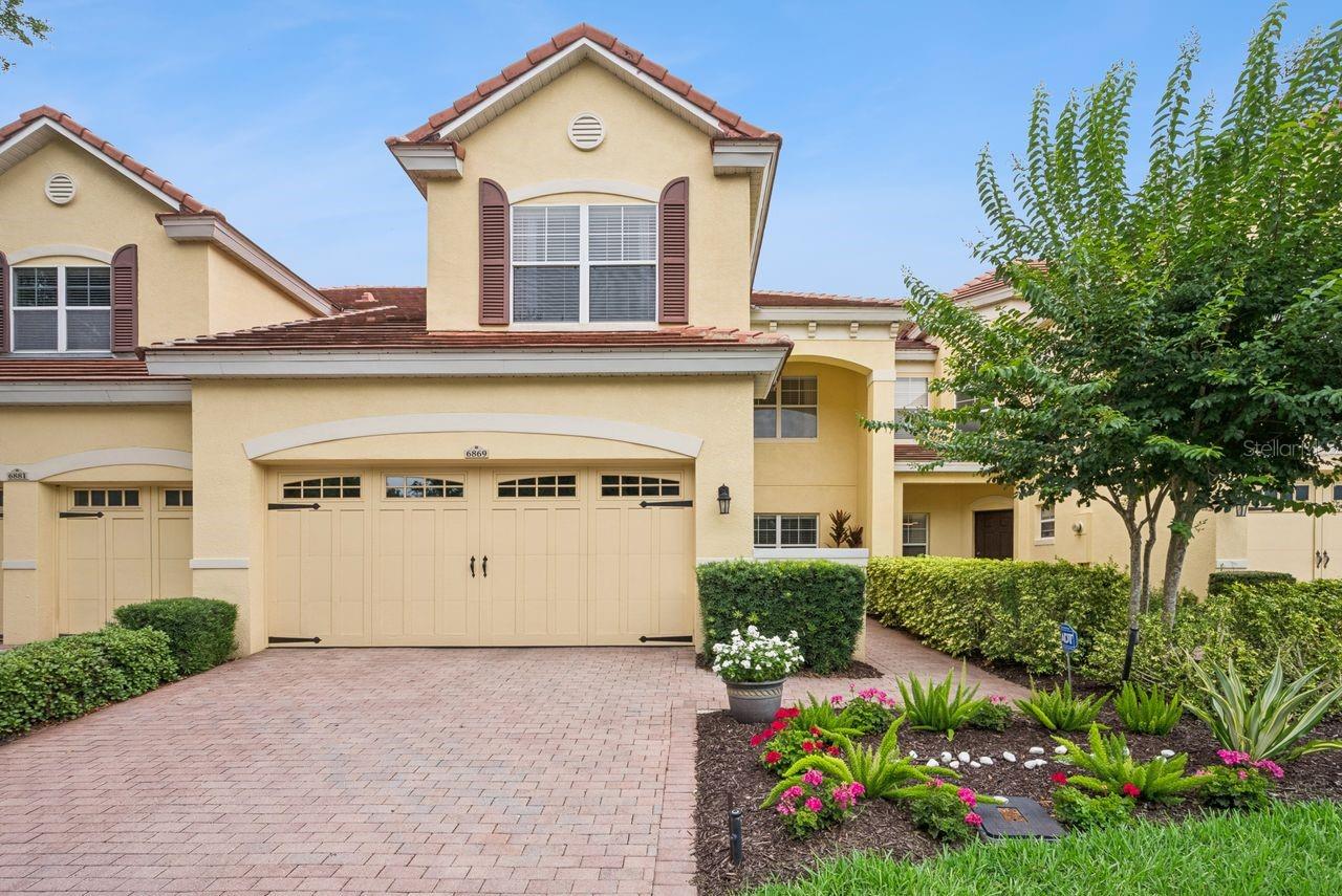 Charming 3 Bedroom, 2.5 bath Townhouse in gated TOSCANA in Dr.Phillips/SW Orlando, in MOVE-IN condition! Located conveniently to nearly everything one would want,, including shopping, restaurants, major road systems, attractions, A-rated schools, OIA, and more, this beautiful townhouse lacks for nothing! Spacious and bright, built by DeLuca Homes, this is the 'Lucia' model, with over 2200 sq ft, including: New Front door & Side lights (2023), Large sunny Kitchen with all appliances, HUGE Great Room with soaring ceilings over 20' feet, aka Living Room-Dining Room combo with hardwood floors (2018) & New Dining & Foyer lighting (2022); DOWNSTAIRS Primary Suite with Primary Bath remodel (2016) includes gorgeous walk-in shower, dual vanities & closets, New Comfort level toilets (2021). Second level living includes 2 spacious Guest bedrooms, full bath, a large cozy Loft & neutral carpet (barely used!), New A/C Handler & outside Condenser (2019). Also in this wonderful property is a downstairs Powder room/half bath, large inside laundry room including washer and dryer & 2-car garage with New garage door (2024). In the rear is a comfortable covered and screened Lanai (screened in 2015) that overlooks a large paver & circular patio with mature landscaping. CBS construction, irrigation, tile roof and more. The HOA takes FULL Responsibility of Roof repairs and replacement, exterior painting, sealing & caulking, AND provides landscaping maintenance & replacement, front & back! This super convenient gated community also has a community pool, gym and management office. Also a community termite bond. A great value and opportunity. Won't last, See it Now!