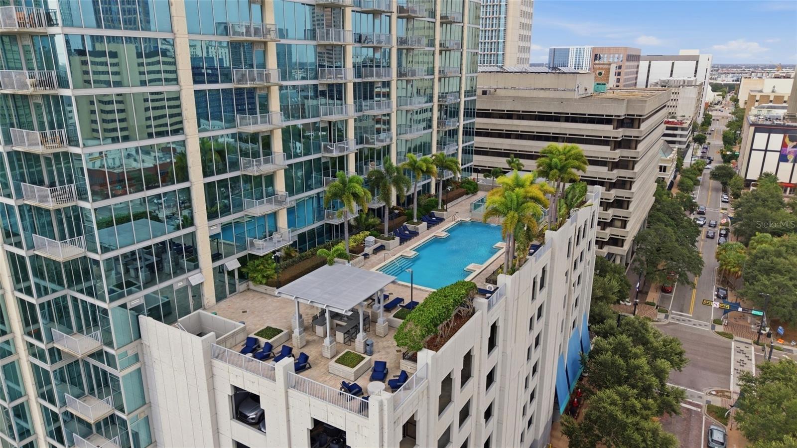 Wake up to breathtaking sunrises, unwind with spectacular sunsets, and experience downtown Tampa from this beautifully redesigned 26th-floor corner residence at SkyPoint. From the moment you enter, you're welcomed by floor-to-ceiling windows, an abundance of natural light, and panoramic views that stretch across the Hillsborough River, downtown skyline, Hotel Floridan, Armature Works, Raymond James Stadium, and beyond. Every day offers a different backdrop—from morning sunshine to glowing city lights and seasonal fireworks visible from the comfort of home. This 2-bedroom, 2-bath residence has been thoughtfully redesigned with a clean, modern aesthetic throughout. The kitchen features quartz countertops, a full-height quartz backsplash, Samsung appliances, and a wine refrigerator, flowing seamlessly into the open living and dining areas designed for entertaining or simply enjoying the view. One of the home's most unique features is its outdoor living space. Two balconies extend directly from the living room, creating the perfect setting for morning coffee, outdoor dining, or watching the city come alive. A third balcony is accessed from the secondary bedroom, providing an additional private retreat. Portions of the outdoor living areas enjoy open sky above, enhancing the views and creating a more open, spacious feel. The split-bedroom floor plan provides comfort and privacy. The primary suite features a custom closet, dual vanities, a separate soaking tub, and a large shower. The renovated guest bathroom offers a spacious shower with a ceiling-mounted rainfall shower head. Throughout the home you'll also find smooth-finish walls, ceilings, and columns, updated flooring, modern lighting, custom closet systems, upgraded interior doors, and smart-home switches and outlets compatible Alexa and other smart home software. Two assigned parking spaces are conveniently located together on the third parking level. Life at SkyPoint extends well beyond your front door. Residents enjoy a heated pool and spa, fitness center with dedicated cardio and weight rooms, theater room, clubroom, billiards lounge, outdoor grilling stations, rooftop park, and 24-hour concierge service. The building also fosters an active community with resident events throughout the year—including summer celebrations, holiday parties, trivia nights, and more—and a private resident app to stay connected and up to date on community announcements. Security and convenience are equally important. Residents benefit from controlled-access entry, security cameras throughout the building, and elevator access that allows residents to access only their own residential floor and building amenities, enhancing both privacy and security. Then there's the lifestyle. Steps to the Tampa Riverwalk for an evening stroll. Spend weekends at Curtis Hixon Waterfront Park enjoying festivals, concerts, and community events. Meet friends at Armature Works, Water Street, or Sparkman Wharf. Catch a Lightning game or concert at Amalie Arena. Ride the historic Tampa Streetcar into Ybor City and watch the exciting Gasworx District continue to transform one of Tampa's fastest-growing neighborhoods. This isn't simply a condominium—it's an opportunity to experience one of the most connected, and vibrant lifestyles Tampa has to offer ! Welcome home!!!