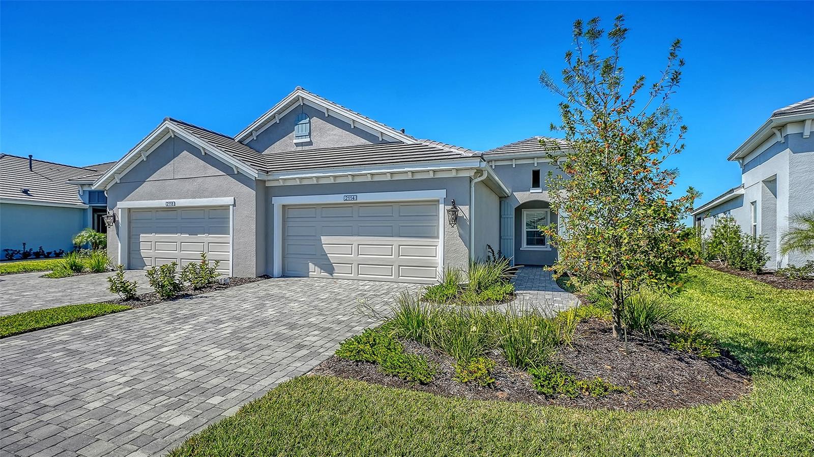 WELCOME TO EASY, ELEGANT LIVING IN THE HIGHLY SOUGHT-AFTER PALM GROVE AT LAKEWOOD RANCH! This TIDEWINDS 2 VILLA offers 1,638 SQ FT OF THOUGHTFULLY DESIGNED LIVING SPACE featuring 2 BEDROOMS, 2 FULL BATHS, A FLEXIBLE DEN/OFFICE, AND A 2-CAR GARAGE. Step into an inviting OPEN-CONCEPT FLOORPLAN with a spacious GREAT ROOM BOASTING 10-FOOT CEILINGS, seamlessly connected to the DESIGNER KITCHEN WITH A CENTER ISLAND, QUARTZ COUNTERTOPS, TILE BACKSPLASH, STAINLESS STEEL APPLIANCES, AND WALK-IN PANTRY. The PRIMARY SUITE FEATURES TRAY CEILINGS, DUAL VANITIES, A WALK-IN SHOWER, AND A GENEROUS WALK-IN CLOSET. At the front of the home, the GUEST BEDROOM AND BATH PROVIDE PRIVACY AND COMFORT FOR VISITORS. Use the additional DEN AS A HOME OFFICE OR FLEX SPACE TO FIT YOUR LIFESTYLE. Step outside to your private SCREENED LANAI BACKING TO PEACEFUL GREENSPACE – ideal for morning coffee or sunset relaxation. Enjoy MAINTENANCE-FREE LIVING IN A GATED COMMUNITY WITH A RESORT-STYLE AMENITY CENTER, including POOL, SPA, FITNESS CENTER, AND PICKLEBALL COURTS. Located just minutes from shopping, dining, top-rated golf courses, and Gulf Coast beaches. EXPERIENCE THE BEST OF FLORIDA LIVING IN A BRAND NEW, NEVER-LIVED-IN HOME — WITH BUILDER WARRANTIES IN PLACE. WHY WAIT TO BUILD? THIS MOVE-IN READY VILLA IS AVAILABLE NOW!
