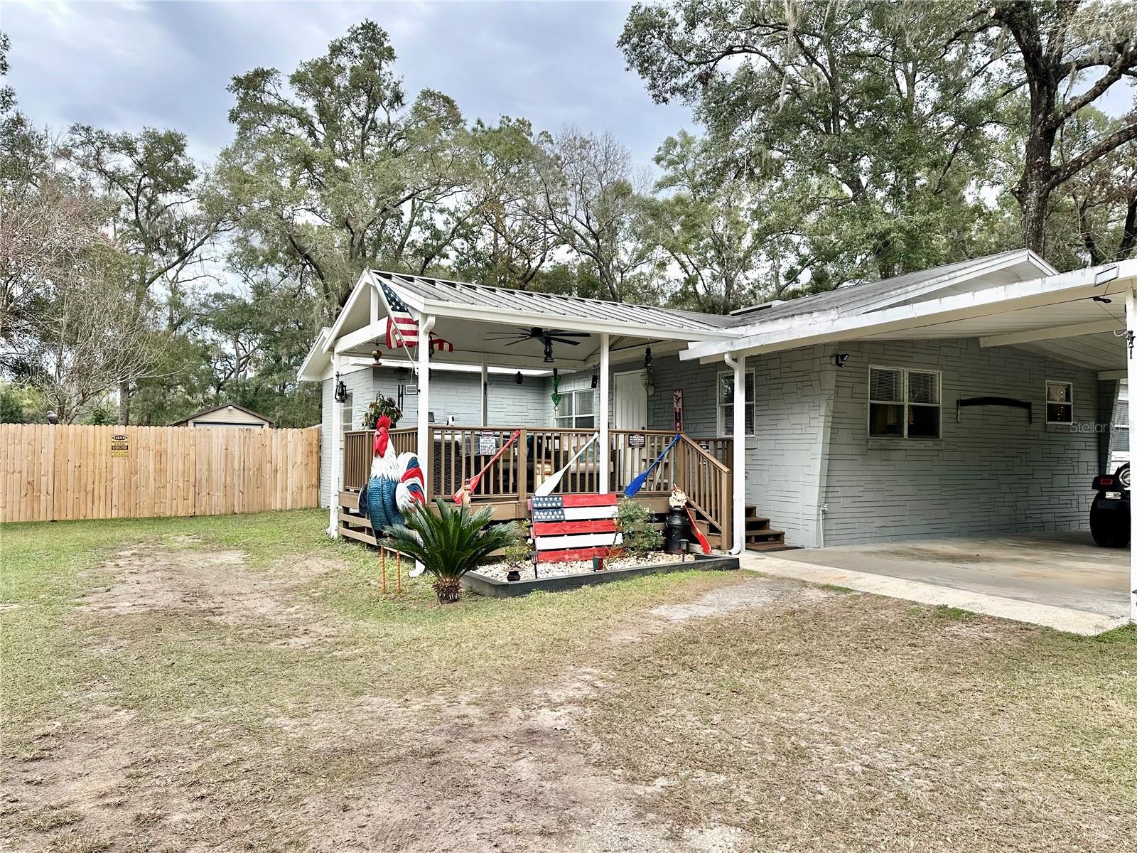 Set on a fully fenced one-acre lot, this well-laid-out 3-bedroom home offers space, privacy, and flexibility both inside and out, all within the Bell Spring community, a unique neighborhood known for its private natural spring, tranquil setting, and authentic Florida charm.

The home features an open floor plan that creates an easy flow through the main living areas, highlighted by electric fireplaces in both the living room and the primary bedroom, adding warmth and character. The kitchen includes an electric range and a fixed center island with generous workspace, opening to a large dining area ideal for everyday living or entertaining. An open laundry space enhances functionality, and the washer and dryer are included.

The home offers three bedrooms, including a spacious primary suite with a walk-in closet and an updated bathroom. One of the secondary bedrooms does not have a closet, allowing flexibility for guest space, a home office, or hobby room.

Out back, enjoy a private outdoor setting complete with a pool, multiple storage sheds, and ample room to relax or entertain. Please note: the newer shed does not convey. The property is part of a community with a low annual association fee of approximately $30, providing key fob access.

Residents of the Bell Spring area enjoy a setting where tranquility, privacy, and natural Florida beauty come together, including access to a community spring known as “Bell Spring.” Optional membership in the Suwannee River Springs Association (approximately $35 per year) provides access to private riverfront parks, a boat launch, and exclusive fishing areas not open to the public.

Located just minutes north of Chiefland, this property offers a rare opportunity to enjoy acreage, outdoor amenities, and a nature-focused community while still remaining close to shopping, dining, and daily conveniences.

With space to spread out, room to personalize, and access to one of the area’s most unique natural settings, this property offers a lifestyle that’s increasingly hard to find.

Schedule your private showing today.