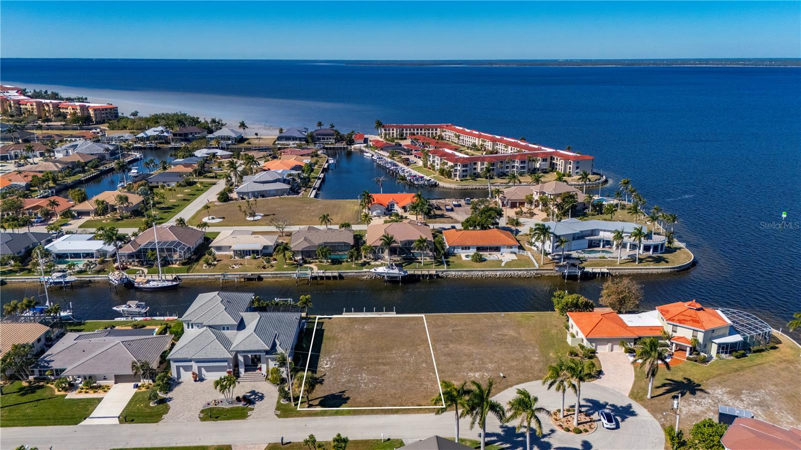 Sailboat Waterfront Lot, just two lots in from Charlotte Harbor, this property is ideally situated for those searching for a true sailboat access and is located in a premier Punta Gorda Isles location providing Direct access to beautiful Charlotte Harbor, the Peace and Myakka Rivers, and the Gulf, some of the Best Boating and Fishing in Southwest Florida is just a moment away.  What an opportunity to build your dream home on this Sailboat Waterfront on quiet Cul de sac.  Beautiful location with 85 feet of water frontage and view of Charlotte Harbor. Public water and sewer are available, and the concrete seawall is maintained by the City of Punta Gorda, plus you will be just a short drive to Historic Downtown Punta Gorda, Fishermen's Village, Dining, Shopping, Golf, Pickleball, Walk, Bike Paths, Waterfront Parks, offering numerous conveniences and amenities.  ***The Adjacent Lot 5 Tropicana is also available****
