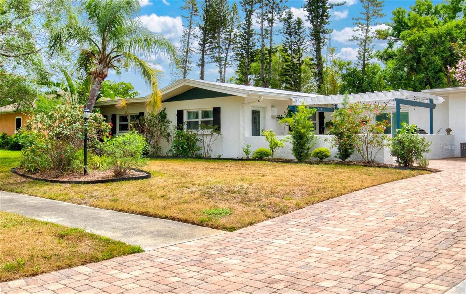 Experience the best of Sarasota living in this beautifully updated single-story ranch home with pool, nestled in sought-after Whitfield Estates—a Manatee County gem with a Sarasota address. Situated near Sarasota Bay, this home sits among multi-million-dollar residences and offers the perfect blend of comfort, charm, and opportunity. This 3-bedroom, 3-bath home welcomes you with bright, open living spaces filled with natural light. The primary bedroom and 2nd bedroom both feature walk-in closets and ensuite baths. The open-concept floorplan connects the living, dining, and kitchen areas—ideal for entertaining or relaxing by the cozy fireplace. A stylish kitchen bar provides extra seating and a central gathering spot. Step outside to your private Florida oasis: a heated pool with screened enclosure, surrounded by lush landscaping on a spacious 1/3-acre lot. Enjoy morning coffee on the front patio with peek-a-boo views of Sarasota Bay, or take an evening stroll to the bay and watch the sunset. Whether you’re searching for a full-time residence, seasonal retreat, or short-term rental investment, this property offers endless possibilities in one of Sarasota’s most desirable neighborhoods. This property is built of concrete block construction, has impact windows, and sits in the desirable X flood zone (flood insurance is not required). Roof is membrane material (2017). AC (2023). For an optional annual HOA fee of just $35, homeowners in Whitfield Estates may obtain a culinary membership at Sara Bay Country Club, granting full access to the clubhouse for dining and social events (golf privileges not included; membership subject to club approval). You and your guests will have plenty of entertainment and convenience options within a short drive including Sarasota Bay, IMG Academy, SRQ Airport, University Towne Center Mall, downtown Sarasota, St. Armands Circle, Lido Key and gulf beaches.