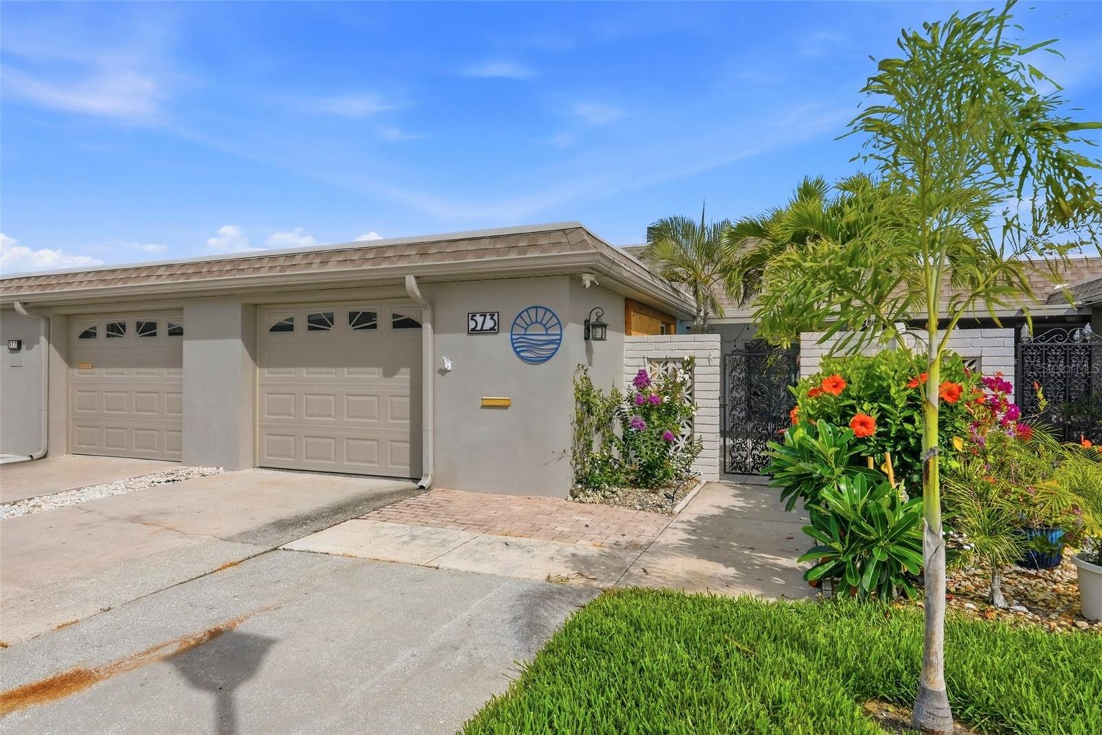 Don’t pass up this opportunity to live where every day feels like a vacation in Boca Ciega Point! This beautifully renovated 2-bedroom, 2 bath waterfront villa exudes coastal elegance and stands out above the rest.  Enjoy the sunsets and stunning Intracoastal Waterway views from your private dock with newly expanded composite decking with cable railing, and a 10,000 lb boat lift with remote. Enjoy true Florida waterfront living with boating, fishing, paddleboarding, kayaking, dolphin watching and relaxing sunsets right from your own backyard. Thoughtfully remodeled with a premium finish level, this villa stands out with quality upgrades throughout plus those little touches that many units do not include. The interior features gorgeous new luxury porcelain flooring throughout, an open kitchen with custom cabinetry, expanded pantry storage, beautiful high end interior doors, new appliances, a reverse osmosis system, tied into the refrigerator water/ice connection. Custom Closets by Design storage has been added throughout, creating a clean, organized, move-in-ready feel. Major recent improvements include a new HVAC system and ductwork with the unit relocated to the attic for added interior storage, all-new floor to ceiling drywall, new blown-in attic insulation, new impact high end front entry door, new hurricane-impact sliders including a panoramic 6-panel dockside door wall with screens, new hurricane-impact overhead garage door and garage window, and Roll-A-Guard electric hurricane shutters on the waterfront side for added protection. Additional upgrades include a brand-new Florida room roof, expanded courtyard roof for weather-protected laundry access, mature courtyard and front garden areas, professional epoxy garage flooring, and expanded garage cabinetry. All county inspections are completed and there are no open permits. The HOA fee includes comprehensive coverage such as multi-peril insurance, water/sewer, trash, cable/internet, escrow reserves, grounds maintenance, and access to community amenities. Boca Ciega Point is one of the area’s most desirable gated 55+ waterfront communities, just minutes from Madeira Beach, Redington Beach, shopping, dining, and everyday conveniences. Amenities include a newly installed kayak launch, bocce ball, shuffleboard, tennis courts, heated community pool, saunas, fitness center, men’s and women’s locker rooms, clubhouse, monthly events, boating club, and more. An absolute must-see rare opportunity to own a move-in-ready waterfront villa with boating access, beautiful views, and an elevated renovation already completed.  The only thing left to do is move in and call it home!