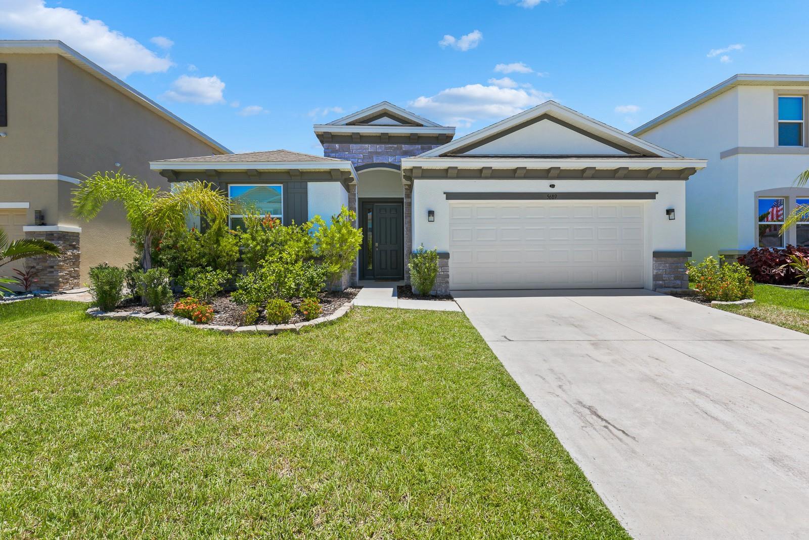 Welcome to this beautifully maintained single-story home in the desirable Mangrove Manor community. Offering 4 bedrooms, 2.5 bathrooms, a 2-car garage, and 2,035 square feet of living space, this home features a functional split-bedroom floor plan, soaring ceilings, recessed lighting, and an open-concept design ideal for both everyday living and entertaining.

At the heart of the home, the spacious kitchen overlooks the living and dining areas, creating a seamless flow throughout the main living spaces. The kitchen is appointed with stone countertops, 42-inch staggered cabinetry, abundant counter space, a large center island with seating, and a full appliance package including a range, microwave, dishwasher, and refrigerator. A casual dining area adjacent to the kitchen provides the perfect spot for everyday meals and conversation.

Privately located at the rear of the home, the bright and spacious primary suite offers a relaxing retreat with an en-suite bathroom featuring a dual-sink vanity, walk-in shower, soaking tub, private water closet, and walk-in closet. Tile flooring extends throughout the primary bedroom and bathroom for added style and easy maintenance.

Bedrooms 2, 3, and 4 are situated toward the front of the home and feature plush carpeting. They share a full bathroom with a tub/shower combination.

Additional highlights include a dedicated laundry room, Smart Home System, covered rear patio perfect for outdoor relaxation, and a spacious 2-car garage.

Residents of Mangrove Manor enjoy access to a community pool and a convenient location near a variety of outdoor recreation opportunities, including the TECO Manatee Viewing Center, local marinas, and E.G. Simmons Park. With easy access to shopping, dining, and major roadways, this home offers the perfect blend of comfort, convenience, and Florida living.

NOTE: Additional $59/mo. Resident Benefits Package is required and includes a host of time and money-saving perks, including monthly air filter delivery, concierge utility setup, on-time rent rewards, $1M identity fraud protection, credit building, online maintenance and rent payment portal, one lockout service, and one late-rent pass. Renters Liability Insurance Required. Call to learn more about our Resident Benefits Package.