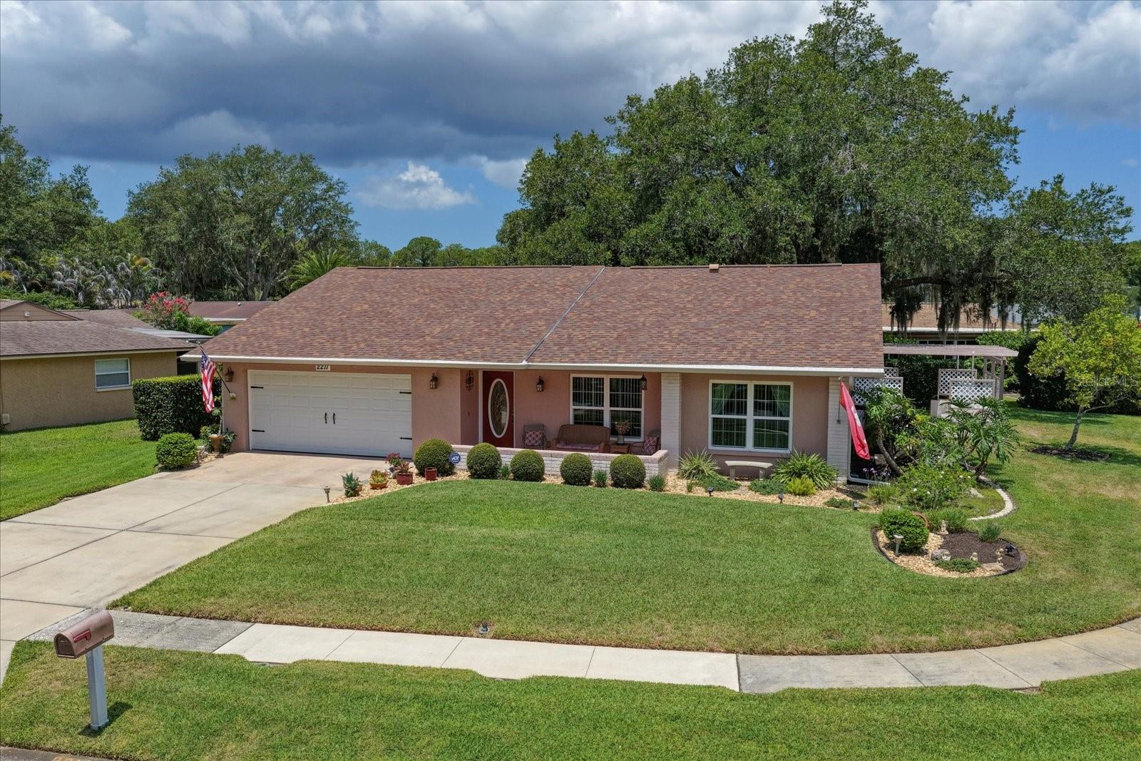 Welcome to the highly sought-after Anchorage of Lake Tarpon, nestled within the desirable East Lake Corridor. This well-established 55+ active adult community is surrounded by natural beauty, mature landscaping, and abundant wildlife, creating a peaceful setting you'll love coming home to. Situated on a beautifully landscaped corner lot, this meticulously maintained, move-in-ready 2-bedroom, 2-bath home with a spacious 2-car garage offers timeless Florida charm.
From the moment you arrive, the inviting curb appeal, covered front porch and lush landscaping make a lasting impression. Step inside to discover a bright, welcoming interior filled with natural light and a thoughtfully designed floor plan that balances formal and casual living spaces.
The spacious formal living room features a large picture window that brings the outdoors in, while the adjacent formal dining room is perfect for holiday gatherings and entertaining. The kitchen offers ample cabinetry, generous counter space, Samsung SS appliances. A casual nook provides the ideal setting for morning coffee and everyday meals.
The kitchen flows seamlessly into the cozy family room, creating a second living area where family and friends can gather. An informal dining space between the kitchen and family room is perfect for playing cards or game night and has access door to the outdoor living space.  
Adding to the home's functionality is a true inside laundry room complete with cabinetry, and a utility sink.
The split-bedroom floor plan offers privacy for both owners and guests. The spacious primary suite is at the rear of the home and features a large walk-in closet and updated ensuite bath with a walk-in shower, tile from floor to ceiling, and wood cabinetry. A split plan, guests will enjoy a secondary bedroom at the front of the home and a full hall bath.
One of the home's desirable features is its indoor-outdoor living design. The expansive pergola covered patio is accessible from the family room, and kitchen, creating a natural extension of the living space, overlooking the beautifully landscaped yard, providing the perfect spot for al fresco dining and entertaining.
The oversized 2-car garage offers abundant storage.  Major updates provide peace of mind, including a new roof (2024), A/C (2016) with new coil (2025), and water heater (2025).
Life in Anchorage of Lake Tarpon extends far beyond your front door. Residents enjoy a remodeled clubhouse and community pool just a block away. The clubhouse features a library, pool table, kitchen, gathering spaces, and a full calendar of social activities.
Outdoor enthusiasts will appreciate the community's prime location adjacent to the Pinellas Trail and 250-acre John Chestnut Sr. Park. A private neighborhood walkway provides direct access to Lake Tarpon's boat launch, walking trails, dog park, playground, and scenic natural surroundings. The community is pet-friendly, and golf cart friendly.
Conveniently located along the East Lake corridor, near the YMCA, premier golf courses, shopping, dining, and medical facilities, this home is also just 20 minutes from award-winning Gulf beaches, Tampa International Airport, professional sports venues, Ruth Eckerd Hall, and the shops and waterfront charm of downtown Dunedin.
This is a rare opportunity to enjoy a classic Florida home in a welcoming, nature-rich community where neighbors become friends, and every day feels like a vacation.  NOT IN A FLOOD ZONE.