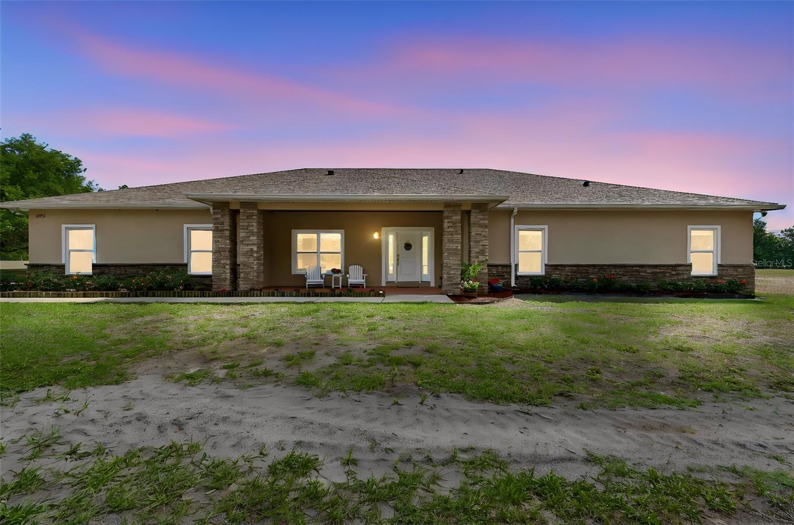 An absolutely MUST-SEE Priced To Sell deeply heartwarming Ranch just north of the new developments along the Highway 52 Dade City Corridor. This extraordinary home only awaits you, your family, and friends to celebrate life together from your very own spacious back and front porches while enjoying the peaceful and serene wildlife and sunsets across your slightly under 5 sprawling acres of amazing Single Family Rural Zoned land. Only minutes away from shopping, restaurants, hiking and Old Florida museums and villages, this ranch is the perfect blend of country living and modern amenities with a spacious Custom Built 3 bedroom, 2.5 bathroom home set among pasture and old Florida live Oaks. This home also offers a 4th room previously used for a movie room, a small home office, an expansive Attic Storage Area, tons of closets for storage, and a oversized Laundry/Mud Room that has potential for many uses.  This horse-friendly property has NO property owners association or deed restrictions, so it is a dream come true for animal lovers desiring to raise chickens, space to play with your pups,  goats, miniature donkeys, potbellied pigs, and for you equestrian enthusiasts out there, riding your horses to your heart's content. This fantastic property also features a Large Mechanics Shop complete with Heavy Duty Vehicle Lift, and a pole barn that has plenty of room for your vehicles and toys including Boats, equipment, or recreational storage. A newer well and water filtration system provides added convenience, ensuring reliable water access.  There is also a secondary septic, water and electric supply for an RV hookup next to the Pole Barn.  The expansive property offers ample room to create your own outdoor oasis, with plenty of space for horses, gardens, or simply enjoying the peace and quiet of rural life. Situated in a serene area, you'll enjoy easy access to the natural beauty of nearby parks and trails. Whether you're looking to embrace a country lifestyle or need room to spread out and enjoy the outdoors with a cup of coffee at daybreak on your expansive back porch, ice cold drink in the afternoon listing to the nature around you, snuggled up with a hot cocoa gazing up at the stars by night, this amazing ranch is the home for you. It's time to stop dreaming and start LIVING your Sunny Florida lifestyle today.