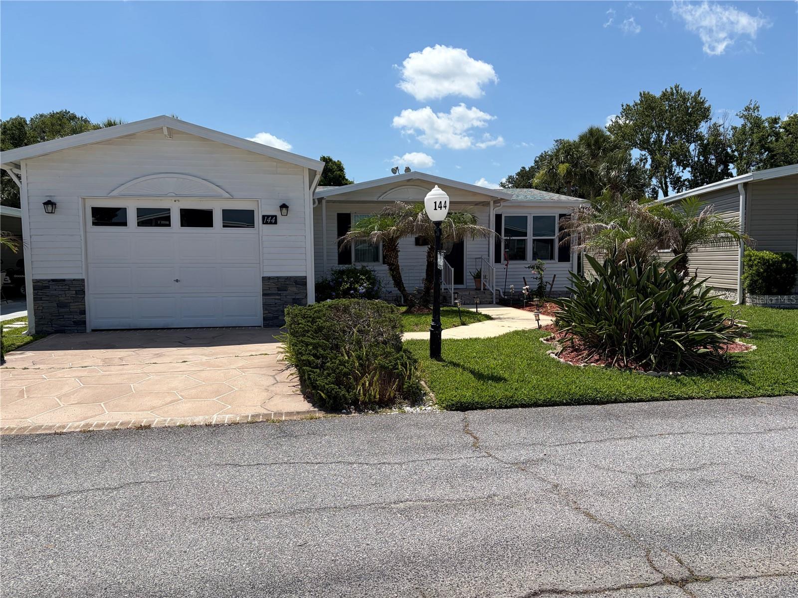 Are you looking for an active 55+ community? You have found one that will check all your boxes.  This friendly community known as Sweetwater Golf and Tennis is just the place. This very well-maintained home has a nice single car garage to keep your vehicle out of the Florida Sun. Being a perimeter home with the pickleball and tennis court behind you gives you entertainment and the knowledge, no neighbors behind you. The roof was installed in 2023 and the A/C unit in 2021. There are new carpeting and laminate flooring throughout the main house with tile in both bathrooms. The electrical breaker box and wiring have been updated. Laundry is located in the garage. This property has a very nice outside sitting area for relaxing and watching the activities of the tennis & pickleball courts. The lanai in not air conditioned but does provide a nice addition to the home for entertaining.  The home is within walking close to the clubhouse and the golf course. 
The Community is located a short distance from shopping and grocery stores, as well as having convenient access to I-4 and Central Florida
activities and attractions.
Residents of Sweetwater Golf and Tennis enjoy an impressive selection of resort-style amenities, including the scenic golf course with affordable green fees, picturesque views of Lake Henry, boating and fishing access, a heated swimming pool, hot tub, fitness center, shuffleboard, bocce ball, horseshoes and a vibrant clubhouse featuring a library, billiards room, game room, full bar, and regular community events and social activities throughout the year. 
With an HOA that covers water, sewer, trash service, cable, and Wi-Fi, this exceptional home delivers the perfect combination of convenience, recreation and carefree Florida living. This is your chance to enjoy the active lifestyle you've been dreaming of in one of the area's most welcoming communities.