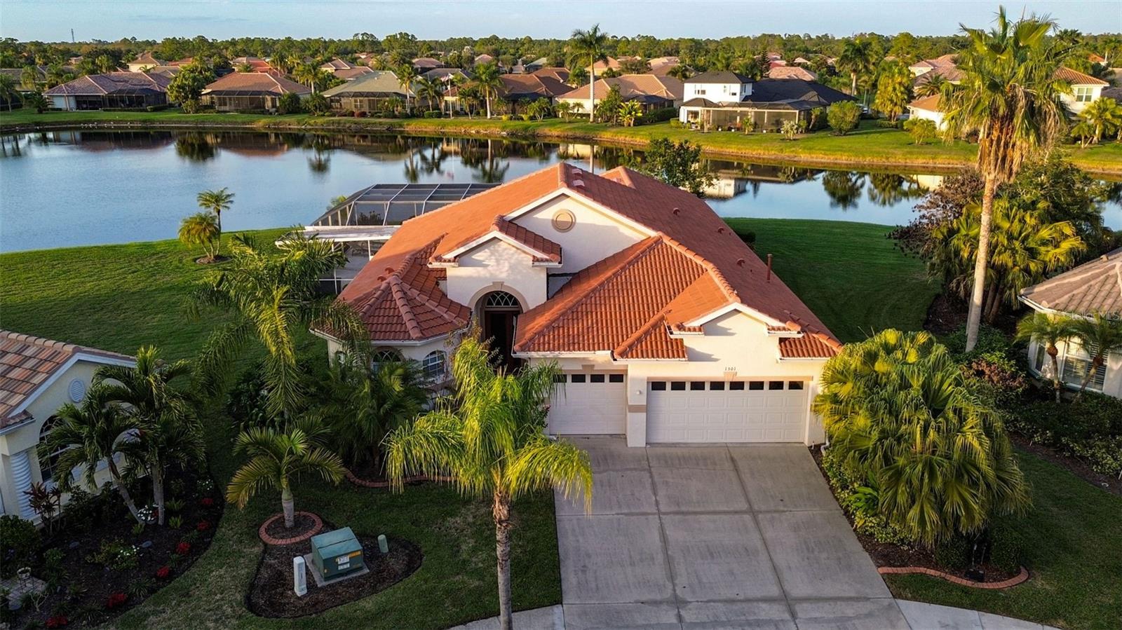 Rare opportunity to own a lakefront home with stunning sunset views on one of the largest and most desirable oversized cul-de-sac lots in all of Heron Creek Golf & Country Club (14,355 sq ft).NEW 2024 TILE ROOF! 
This 4-bedroom + den, 3-bath, 3-car garage home offers 2,711 sq ft with an open layout, 11-ft tray ceilings, and fresh interior paint and new flooring (2023). The kitchen features maple cabinetry, granite countertops, center island, and breakfast nook, overlooking the custom pool and spa—perfect for entertaining.
The private owner’s suite includes lanai access, two walk-in closets, and a spa-style bath with jacuzzi tub, oversized shower, and dual vanities. Split floor plan provides guest privacy.
Mature landscaping, excellent curb appeal! Club membership offers championship golf, tennis, fitness center, resort-style pool, dining, and social events.
Ideally located near I-75, beaches, shopping, dining, and airports. A move-in-ready lakefront home with a brand-new roof on one of the best lots in the community.