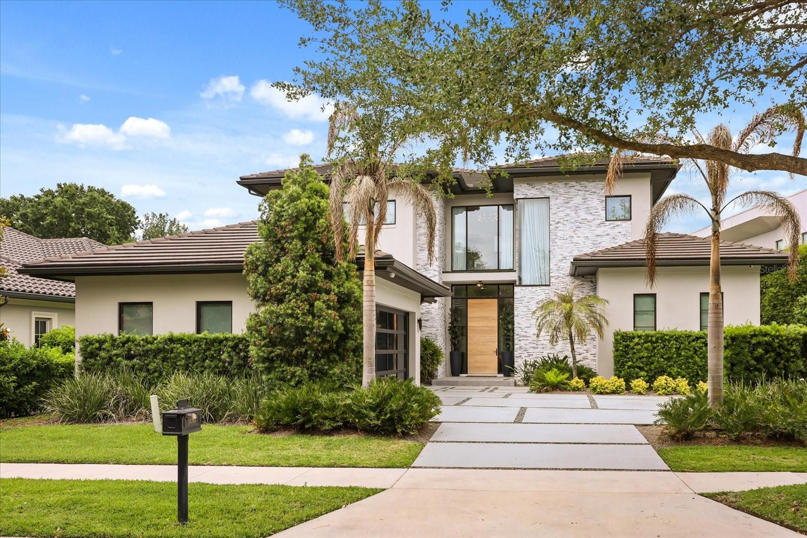 Nestled within the exclusive gated enclave of Lake Nona Golf & Country Club, 10348 Kensington Shore Drive presents a rare 2022-built modern masterpiece that redefines sophisticated living.
    As you enter, your eye is immediately drawn to the exquisite marble flooring that flows throughout the 3,964 square feet, complemented by custom warm lighting that bathes every room in an elegant glow.  The gourmet kitchen serves as the heart of the home, boasting an oversized waterfall island, premium stone countertops, and extensive custom cabinetry — an entertainer’s dream perfectly suited for intimate family dinners or grand gatherings. This seamless open-concept design flows into sophisticated living spaces, where a sleek electric fireplace creates an intimate ambiance. Expansive sliding glass doors invite abundant natural light and effortlessly connect the indoors to the breathtaking outdoor sanctuary.
    Each of the four generously proportioned bedrooms features its own luxurious en-suite bath. The main-level primary suite is an exceptional private retreat, complete with a spa-like bathroom, oversized walk-in closet, and private laundry. An upstairs loft provides versatile space for a refined home office, media room, or additional gathering area.
Discerning details abound, including a sophisticated smart home system, dual upgraded refrigerators, dual dishwashers, dual washers and dryers, and designer ceiling fans throughout.
    The private quarter-acre lot offers unparalleled tranquility, overlooking two serene ponds with no rear neighbors. This resort-style backyard oasis features a heated pool and spa, a fully equipped screened outdoor kitchen, two custom fire pits, an elegant outdoor fireplace, and meticulously landscaped gardens — creating the ultimate setting for both intimate evenings and unforgettable entertaining.
Situated in the community’s most desirable walkable location, residents enjoy effortless access to the championship golf course, resort-style pool, world-class fitness center, tennis and pickleball courts, and the exclusive clubhouse with fine dining. This premier gated community provides 24/7 manned security, round-the-clock concierge services, and a secure, family-oriented lifestyle where children can safely explore by foot or golf cart.
This is Lake Nona living at its absolute finest!
Ready to experience this exceptional home? Let’s schedule your private tour today.