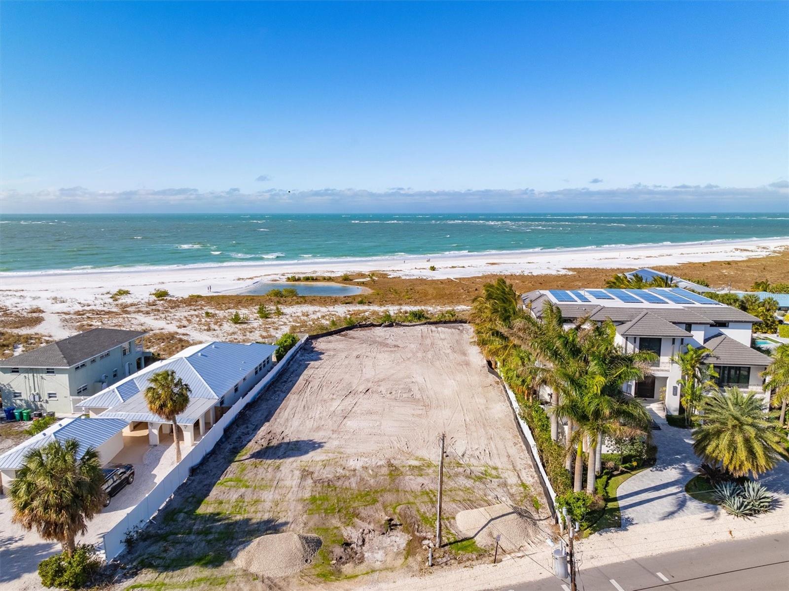 *State DEP permit in hand and ready to build - lot comes with complete custom home plans.* Just get your city permit or personally design your dream home on the beach! Stunning estate sized Gulf-front property located at 769 N Shore Dr, Anna Maria, FL. This cleared lot is almost one full-acre with 102' of beach frontage, offering direct access to the pristine white sand beaches of the Gulf of Mexico. Full 180-degree views of the beach and Gulf of Mexico. Year-round sunset views.  Enjoy the convenience of walking to the charming restaurants and boutique shops of Anna Maria from your dream coastal haven.