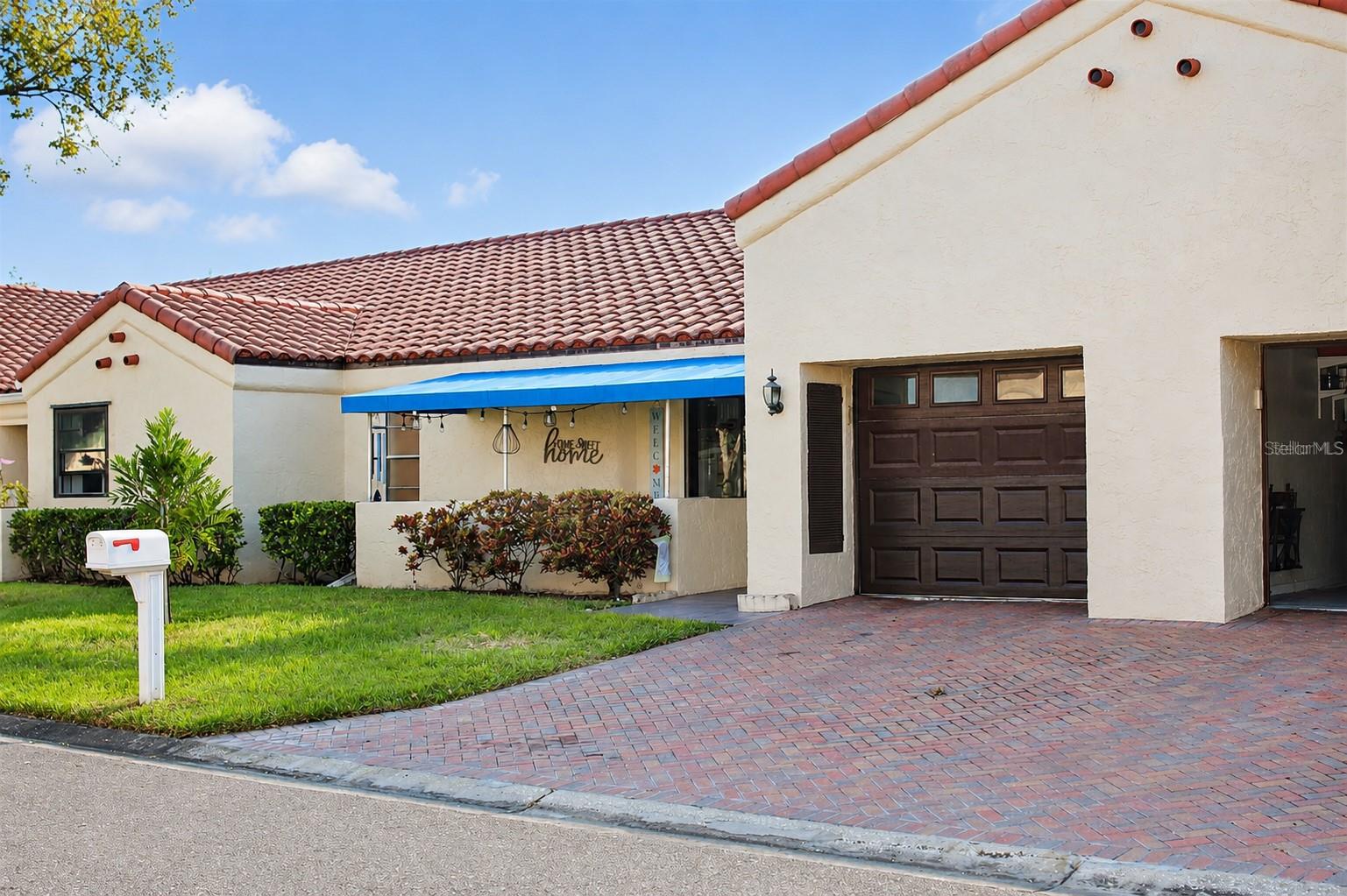 PRICE IMPROVEMENT! Experience the Florida Lifestyle You've Been Waiting For!

Welcome to this beautifully maintained 2-bedroom, 2-bath villa nestled within the highly desirable Mainlands of Tamarac by the Gulf, an established 55+ active adult community known for its welcoming atmosphere, maintenance-free lifestyle, and convenient Pinellas County location.

From the moment you arrive, you'll appreciate the inviting curb appeal and relaxed Florida charm. Inside, the thoughtfully designed floor plan offers spacious living and dining areas filled with natural light, creating the perfect setting for both everyday living and entertaining. The comfortable family room provides additional living space, while the generous primary suite features a walk-in closet and private bath. A spacious guest bedroom offers flexibility for visiting family and friends, hobbies, or a home office.

Enjoy your morning coffee on the covered front porch, unwind on the private patio after a day at the beach or golf course, and embrace the easygoing lifestyle that makes Florida living so special.

Designed for comfort and peace of mind, this home features an attached one-car garage, hurricane shutters, sliding glass doors, ceiling fans, central air conditioning, and a well-maintained interior ready for its next owner.

One of the greatest advantages of living in the Mainlands is the exceptional maintenance-free lifestyle. The HOA provides outstanding value by covering exterior maintenance, roof replacement, lawn care, irrigation, water, sewer, trash, cable television, internet, and road maintenance, allowing you to spend more time enjoying life and less time maintaining your home.

Residents enjoy a vibrant social environment with a heated community pool, clubhouse activities, neighborhood events, golf-cart-friendly streets, and convenient access to the public Mainlands Golf Course. Whether you enjoy meeting neighbors, participating in community activities, or simply relaxing in a peaceful setting, you'll appreciate everything this established community has to offer.

Ideally located just minutes from award-winning Gulf beaches, downtown St. Petersburg, Tampa International Airport, St. Pete-Clearwater International Airport, shopping, dining, entertainment, medical facilities, and major commuter routes, this home offers the perfect combination of convenience and Florida lifestyle.

Now offered at a recently improved price, this is an outstanding opportunity to own a move-in-ready home in one of Pinellas County's most desirable active adult communities.

Schedule your private showing today and start enjoying the Florida lifestyle you've earned!

Some images have been professionally enhanced for lighting, color balance, and image clarity only. No structural features, finishes, views, landscaping, or property characteristics have been altered or misrepresented.