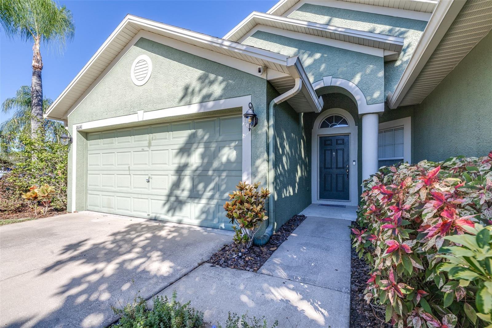 Located in the prestigious gated community of Ivy Lake Estates, this meticulously maintained home offers 3 bedrooms, 2 baths, a 2-car garage, and 1,710 sq. ft. of comfortable living space. Step inside through the foyer and you’ll be greeted by an open floor plan that is light and bright, with volume ceilings in the main living areas. The family room, dining room, and kitchen connect effortlessly, creating a warm and inviting atmosphere perfect for gatherings. The kitchen features stainless steel appliances with a 5-burner gas stove, recently installed quartz countertops, a modern backsplash, and an undermount stainless steel sink and faucet. There’s plenty of storage with a walk-in pantry and a functional work island, while sliding doors lead out to the covered, extended screened-in lanai—ideal for relaxing or entertaining outdoors. The thoughtful split floor plan offers privacy, with the spacious primary suite boasting two walk-in closets and an en-suite bathroom featuring a garden tub, walk-in shower, and a single vanity. The other two bedrooms are located on the opposite side and share a full bathroom. The rich glow of dark bamboo hardwood floors enhances the elegance of the living space. Many improvements and upgrades include: stainless steel kitchen appliances (2019), quartz countertops, undermount sink, and faucet (2024), seven new recessed LED ceiling lights (2024), new roof with upgraded shingles (2019), energy-efficient 16 SEER HVAC (2020), 40-gallon gas water heater (2018), bamboo hardwood floors (2017), water softener (2016), and Ring alarm system. Low HOA fees and no CDD fees. The community features parks, playgrounds, a basketball court, and a picnic pavilion, with nearby access to the Pinellas Bike Trail. Conveniently located near shopping, schools, and medical facilities, with easy access to the Veterans Expressway, Tampa International Airport, Tampa Premium Outlets, and a short drive to the beaches.