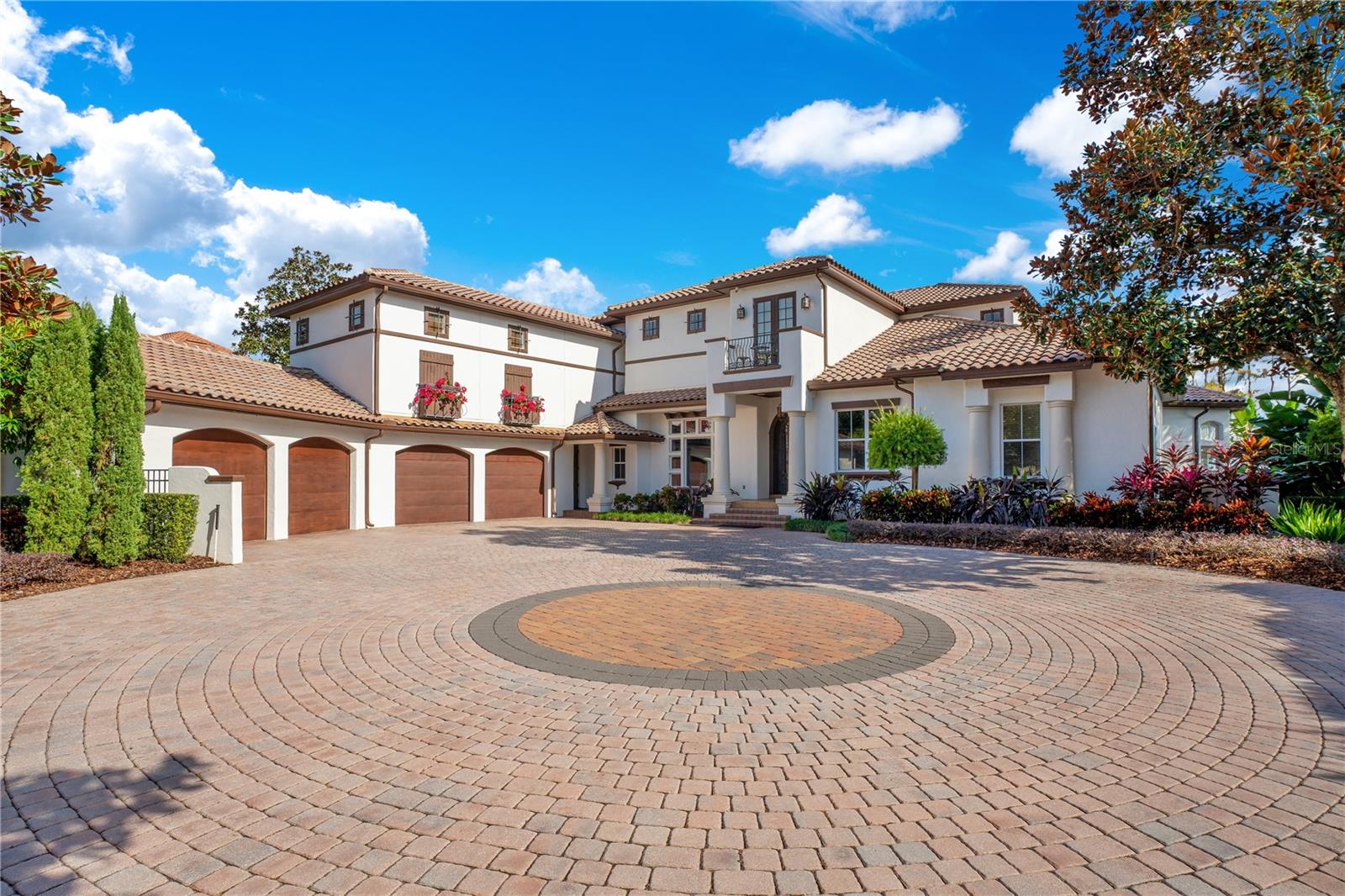 Welcome to this exquisite high-end luxury lakefront home at 6013 Greatwater Drive, located on a premium lot on a cul-de-sac in the exclusive, 24 hour guarded Keenes Pointe neighborhood of Windermere, Florida. This property boasts a prime location on Lake Tibet Butler, offering breathtaking views from most any room in the home, as well as unmatched tranquility.

Beyond your brick-paver circular driveway, you'll step inside the grand entrance and immediately notice the jaw-dropping attention to detail and superior craftsmanship throughout, adorned with high-end fixtures and architectural surprises at every turn. This stunning residence offers five bedrooms, each complete with their own California closets, providing ample storage space, organization, and a touch of luxury to every bedroom. Additionally, there are 5 full bathrooms and two half bathrooms, ensuring convenience and privacy for everyone. The impressive primary suite presents many unique features, including a natural gas fireplace, electric window shades, his and hers closets, as well as an exquisite ensuite bathroom.

The kitchen is a true culinary masterpiece, featuring top-of-the-line Wolf appliances, ensuring that every meal is prepared with precision and style. It even boasts "hidden" luxuries like the enormous Subzero refrigerator, dishwasher, warming drawer, ice maker and more. Two wet bars- one off the living room, and one in the game room complete the entertainment appeal of this prestigious home. Speaking of entertainment, this legacy property has taken it to the next level with a dedicated movie theater providing the ultimate cinematic experience right at home. The downstairs game room, complete with a bar and dedicated space for three TVs, is an ideal space for hosting gatherings and enjoying quality time with friends and family. Plus, it connects to the aw-inspiring screened-in outdoor summer kitchen and pool area overlooking the lake. 

Outside, unwind in the waterfall accented infinity-edge saltwater pool, perfect for enjoying the Florida sunshine and cooling off on hot summer days. Adjacent to the pool, you'll find a luxurious saltwater spa, offering a serene retreat for relaxation and rejuvenation. The entire estate is enveloped in carefully curated Florida-friendly landscaping, creating a true Florida paradise that follows through all the way to your private dock. Two boat lifts allow for easy access to Lake Tibet Butler, just one of the pristine lakes on the Butler chain of lakes, making it a superb recreational destination. 

Car enthusiasts will appreciate the four-plus car garage, providing ample space for vehicles and storage. There's even a designated golf-cart bay! 
Keenes Pointe also boasts many of its own luxuries, including a private boat ramp and playground. Residents here also have the opportunity to join the Golden Bear Club, a private country club with world renowned designer golf course and luxury clubhouse.

Don't miss the opportunity to experience the true Florida lifestyle and luxury living at its finest in this exceptional lakefront home! Watch the virtual tours for a more in depth look at this fantastic estate!

<div style="padding:56.25% 0 0 0;position:relative;"><iframe src="https://my.matterport.com/show/?m=SKEnsoGs2nu&mls=1" frameborder="0" allow="autoplay; fullscreen" allowfullscreen style="position:absolute;top:0;left:0;width:100%;height:100%;"></iframe></div>