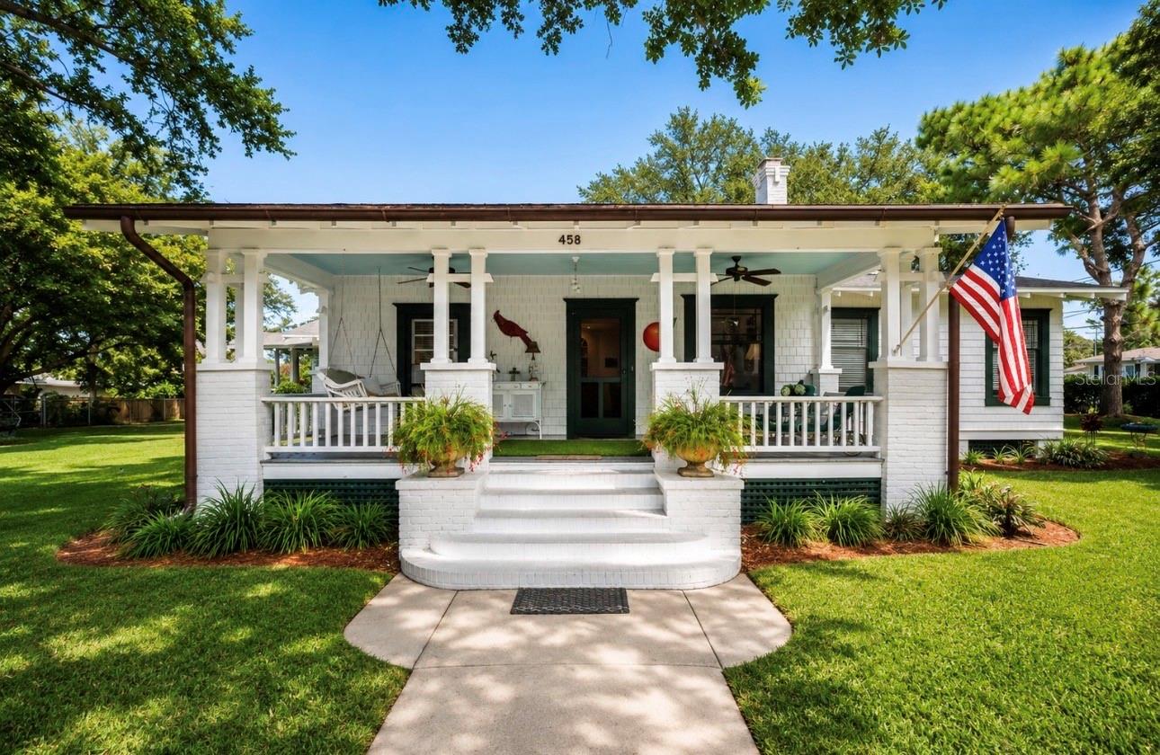 Step back in time and discover one of Downtown Dunedin’s most extraordinary opportunities. Nestled on an exceptionally large approximately 0.60-acre parcel just moments from the heart of downtown, this rare circa-1915 historic home offers a lifestyle that is nearly impossible to recreate. Surrounded by mature trees and lush landscaping, the property feels like a private retreat while placing you just a short stroll from Main Street’s award-winning restaurants, breweries, boutique shopping, waterfront parks, marina, and year-round festivals.

From the moment you arrive, the welcoming front porch, charming white picket fence, natural gas lantern, and timeless architectural details create an unforgettable first impression. Inside, rich character abounds with soaring 10-foot ceilings, beautiful heart pine flooring, elegant crown molding, original built-in china cabinetry, and a cozy wood-burning fireplace that serves as the heart of the home. Every room reflects the craftsmanship and warmth of a bygone era while offering the comfort and functionality desired for modern living.

Beyond the home’s undeniable charm lies one of its greatest assets—the incredible property itself. The expansive lot provides endless possibilities for enjoying outdoor living, future expansion, or simply embracing the privacy and space that is almost unheard of in Downtown Dunedin. Adding even more value is the spacious detached garage, offering exceptional room for vehicles, storage, hobbies, or a workshop—an increasingly rare feature in the downtown district.

Thoughtful updates preserve the home’s historic integrity while providing peace of mind, including an architectural shingle roof (2020), two separate HVAC systems (newest replaced July 2022) with transferable service agreements, solar roof vents, and copper gutters that add both beauty and longevity. The home is also situated approximately 24 feet above sea level according to USGS records.

Zoned Downtown Core (DC) Commercial, this unique property offers exceptional flexibility and tremendous long-term potential beyond its current residential use. Whether you envision preserving it as a treasured historic home, creating an income-producing investment, or exploring future possibilities, this is a truly unique opportunity. Buyers should verify all zoning regulations, permitted uses, and future development opportunities directly with the City of Dunedin.

Rarely does a property combine historic charm, an oversized lot, a substantial detached garage, incredible versatility, and one of the most desirable locations in Downtown Dunedin. This is more than a home—it’s an opportunity to own a piece of Dunedin’s history while investing in its future. Schedule your private showing today.