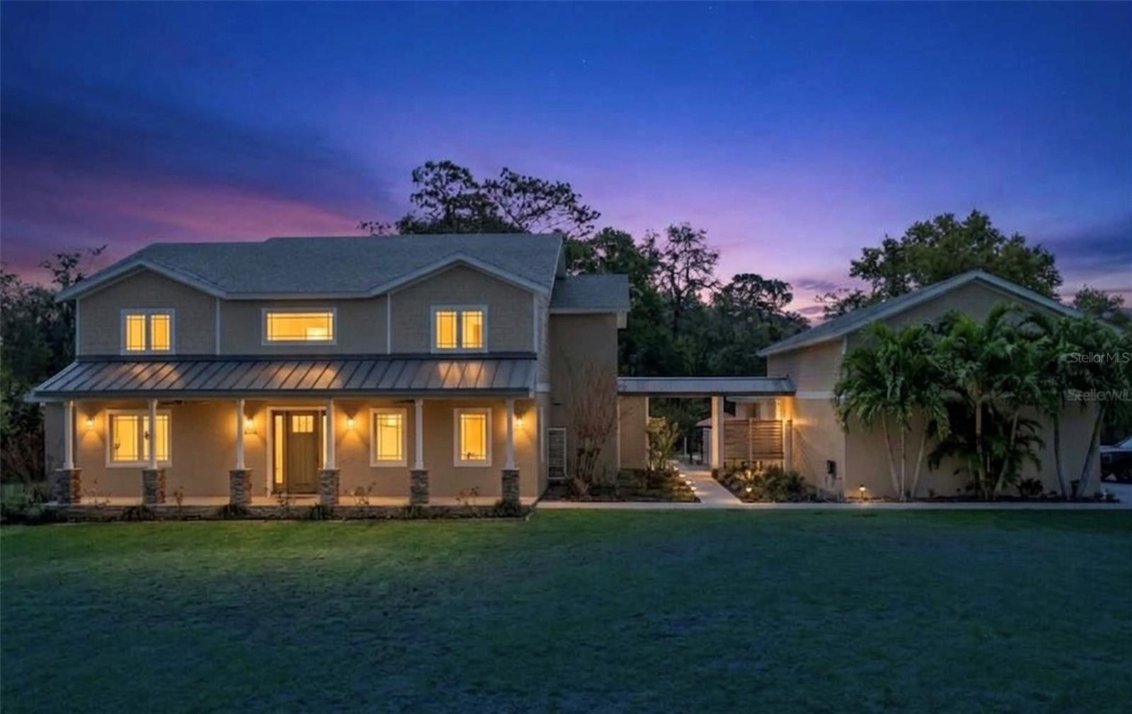 Virtually Staged. Private 4.13 acre GATED ESTATE in beautiful Beauclair Ranch Club-an EQUESTRIAN community offering space,privacy,and exceptional functionality. This CUSTOM BUILT property truly has it all! The estate features a 3,444 SF MAIN residence with 4 bedrooms, 3.5 baths, and a DEDICATED OFFICE. Also included is a fully equipped, detached ADDITIONAL RESIDENCE (ADU) with FULL KITCHEN, LIVING ROOM, BEDROOM, and BATH-ideal for MULTIGENERATIONAL LIVING, a work from home private retreat, or INCOME POTENTIAL. Designed for both everyday living and entertaining, the main home offers an open concept layout centered around a chef's kitchen and a stunning wood burning fireplace. The well appointed kitchen is equipped with THERMADOR APPLIANCES, a six burner propane gas range, QUARTZ countertops, a large island, and abundance of CUSTOM CABINETRY. A built in WET BAR with WINE STORAGE and beverage refrigerator enhances the entertaining space. Extensive property upgrades provide efficiency, security, and long term resilience, including a NEW ROOF (2025), OWNED SOLAR system with 5 BATTERY BACKUPS, Three TESLA charging stations, TWO WELLS ( one backup), 1000 GALLON buried PROPANE TANK, 3 TANKLESS HOT WATER HEATERS, and a WHOLE HOUSE WATER FILTRATION and SOFTENING SYSTEM. Security and preparedness features include a FEMA RATED SAFE ROOM, 3M SECURITY WINDOW FILM, RING doorbell and a LOREX SECURITY SYSTEM WITH CAMERAS. The property is built for lifestyle and storage, featuring a THREE CAR detached garage with a BENDPAK CAR LIFT, a full length garage attic with built in shelving, and ample space for cars, boats, RV's and recreational toys. Outdoor amenities include a WELLIS SPA, large CUSTOM FIRE PIT, MATURE FRUIT TREES, a FENCED GARDEN AREA, and expansive open land with plenty of room to add your dream pool. Located just minutes from the HARRIS CHAIN OF LAKES PUBLIC BOAT RAMP, this property offers convenient access to Central Florida's premier boating and fishing waters. A rare combination of craftsmanship, acreage, upgrades and versatility in a gated equestrian setting, this property is a one of a kind don't miss opportunity!