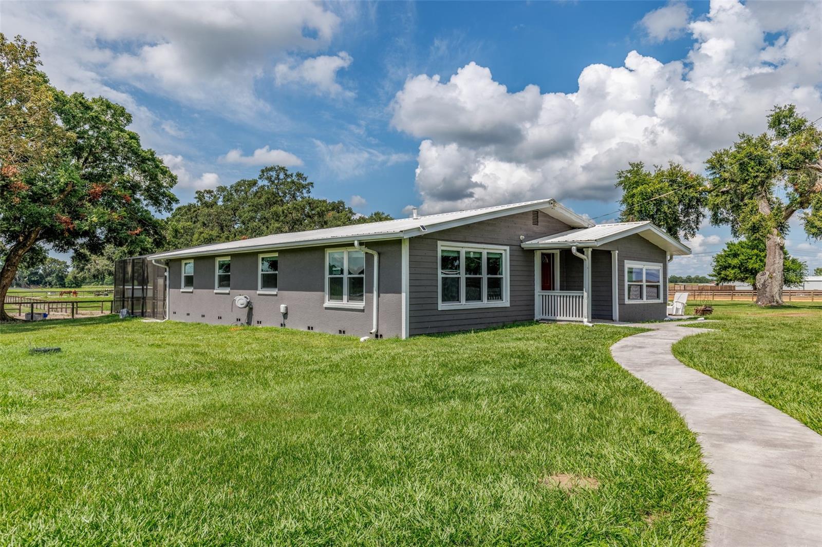 NO HOA • FLOOD ZONE X • VERY LOW PROPERTY TAXES • 52.33 ACRES • 3 RESIDENCES • 28 STALLS • TURNKEY EQUINE FACILITY

Rare opportunity to purchase a fully operational 52.33-acre equestrian facility in the heart of Florida horse country. Nearly every major improvement on this property has been completed within the past few years, creating a truly turnkey operation where a new owner can immediately move horses, equipment, and business operations onto the property without the expense, delays, and headaches of new construction.

Property Features Include:

• 52.33 Acres
• 3 Residential Homes
• 28 Stalls Across Multiple Barns
• Room for Additional Barns and Stalls
• Multiple Feed Rooms and Tack Rooms
• Wash Racks with Hot and Cold Water
• Automatic Waterers in Every Stall and Field
• Fly Spray Systems
• Hot Walker
• Round Pen
• Arena
• Multiple Large Pastures
• Multiple Paddocks
• New Four-Board Fencing
• No-Climb and Electric Fencing
• Hay Barns
• Shavings Barn
• Storage Barns
• Shop and Equipment Storage Facilities
• 7-Bay Equipment Garage
• RV/Camping Sites with Water, Electric and Sewer
• Security Camera Systems
• Multiple Gated Entrances
• High-Speed Fiber Optic Internet Available

Recent Improvements Include:

• New Barn Construction
• New Residential Construction
• New Arena
• New Round Pen
• New Perimeter Fencing
• New Gates
• New Auto Waterers
• New Pasture Shelters
• Updated Primary Residence
• New Hurricane Impact Windows
• New Screened Pool Enclosure
• New Pool Equipment Including Heater and Chiller
• New Utility Infrastructure
• New Water Systems

The primary residence has been extensively updated and features concrete block construction, hurricane-impact windows, a screened pool enclosure, upgraded pool equipment, and numerous recent improvements. Additional residences provide flexibility for staff housing, trainers, guests, rental income, or multi-generational living.

Located less than 30 minutes from the World Equestrian Center, less than 15 minutes from the Florida Horse Park, less than 15 minutes from The Villages, and with convenient access to both Orlando and Tampa International Airports.

This facility was designed with efficiency, functionality, and ease of maintenance in mind. The significant investment of time, planning, and capital has already been made. Nearly every major component of the farm is new or recently improved, allowing a new owner to focus on horses and business operations rather than costly infrastructure projects.

Whether your goals include breeding, training, boarding, rehabilitation, competition horses, or private equestrian use, this property offers the rare opportunity to step into an established operation with substantial room for future expansion. The acreage, layout, and infrastructure provide the ability to add additional stalls, barns, or amenities as your operation grows.

Properties of this size, condition, and location rarely become available. Move your horses, move your business, and start operating from day one.