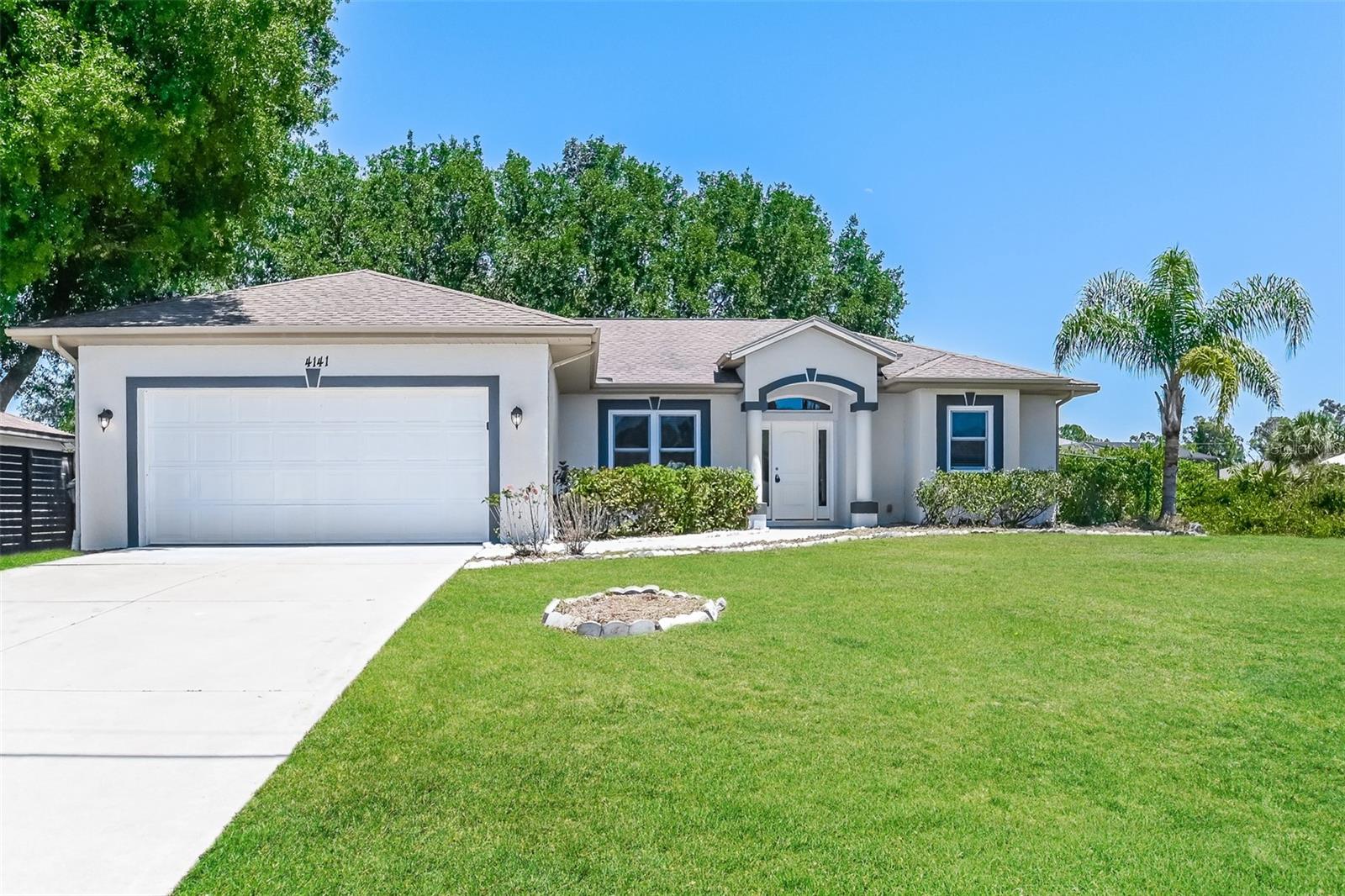 Welcome home to this move-in ready single story home in North Port. This home features high ceilings, tile and laminate flooring, and plenty of natural light throughout. The kitchen offers a functional layout with space for a casual dining setup. Sliding doors lead to a spacious backyard with a covered patio and plenty of room for outdoor living or future customization. Easy to show!