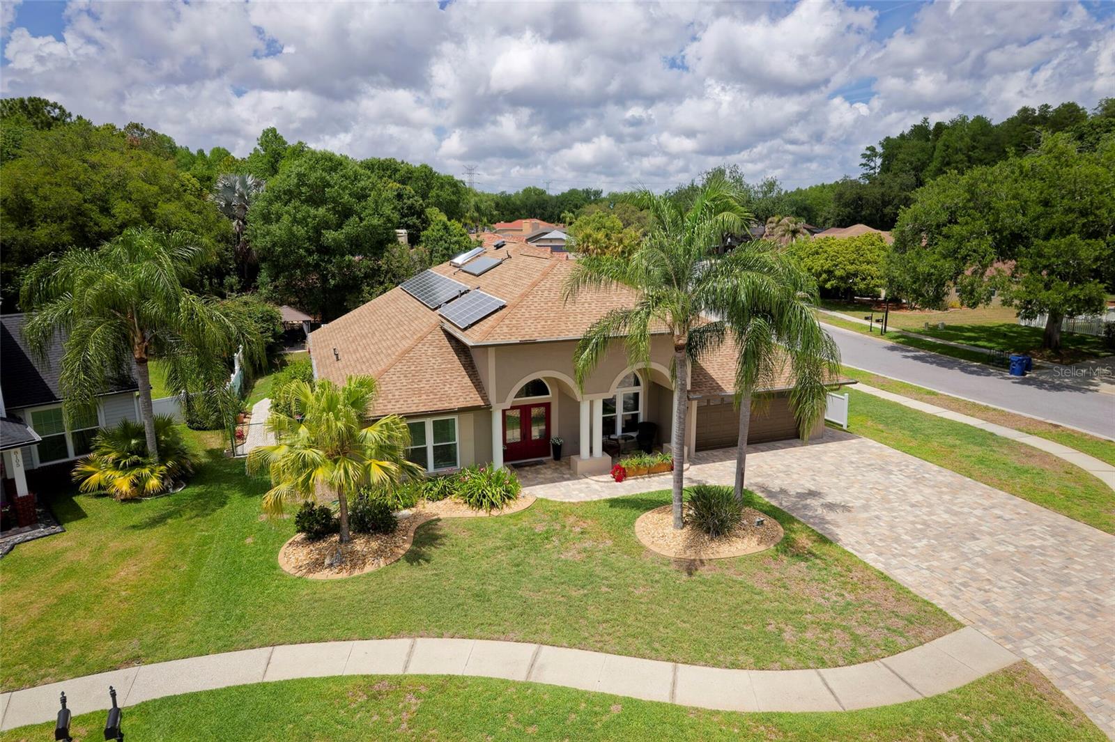 Welcome home to this stunning 4-bedroom + office, 3-bath, 2-car garage pool home located in the highly desirable Trinity Oaks community, just a short walk to some of Trinity’s top-rated schools. Nestled on a private corner lot at the end of a quiet cul-de-sac, this beautifully maintained home offers exceptional curb appeal, privacy, and an ideal layout for both everyday living and entertaining.

Step through the new double leaded-glass entry doors into a grand foyer featuring soaring tray ceilings, crown molding, and abundant natural light. The formal dining room and private office create elegant yet functional living spaces, while the dramatic living room showcases impressive 20-foot ceilings, a custom fireplace feature wall, and built-in shelving. Expansive architectural windows and 9-foot pocket sliding glass doors seamlessly connect the indoor living space to the outdoor oasis.

The gourmet kitchen is a chef’s dream with ample granite countertop space, custom soft-close cabinetry, pull-out shelving, pot drawers, abundant pantry storage, stainless steel appliances, pot filler, oversized island, and eat-in bar perfect for casual dining and entertaining.

Designed with a spacious split-bedroom floor plan, this home offers privacy and flexibility for families and guests alike. Two secondary bedrooms share a beautifully updated Jack-and-Jill bath, while the third guest bedroom features custom built-ins, a desk, and charming window seat adjacent to another updated full bath with custom tile work, marble shower flooring, and upgraded cabinetry.

The luxurious primary suite offers a relaxing sitting area and private sliding glass door access to the pool area. The spa-inspired ensuite bath features custom tile work, dual vanities, Jacuzzi tub with TV, and oversized his-and-hers walk-in closets.

Step outside to your private backyard retreat featuring a screened pavered lanai, sparkling pool with Diamond Brite finish, pergola, grilling area with lighting and electric, mature landscaping, and fully fenced yard perfect for entertaining year-round.

Additional upgrades include energy-efficient windows and doors, solar hot water heater, owned solar system with 13 panels helping offset approximately half of the electric bill, variable-speed pool pump, new A/C installed in 2025, and professional exterior/interior painting completed in 2026.

This exceptional Trinity Oaks home truly offers the perfect combination of luxury, comfort, energy efficiency, and location. Be sure to view the virtual tour and Matterport.
Schedule your private tour today and make this exceptional Trinity home with a 1 year Home warranty yours tomorrow!