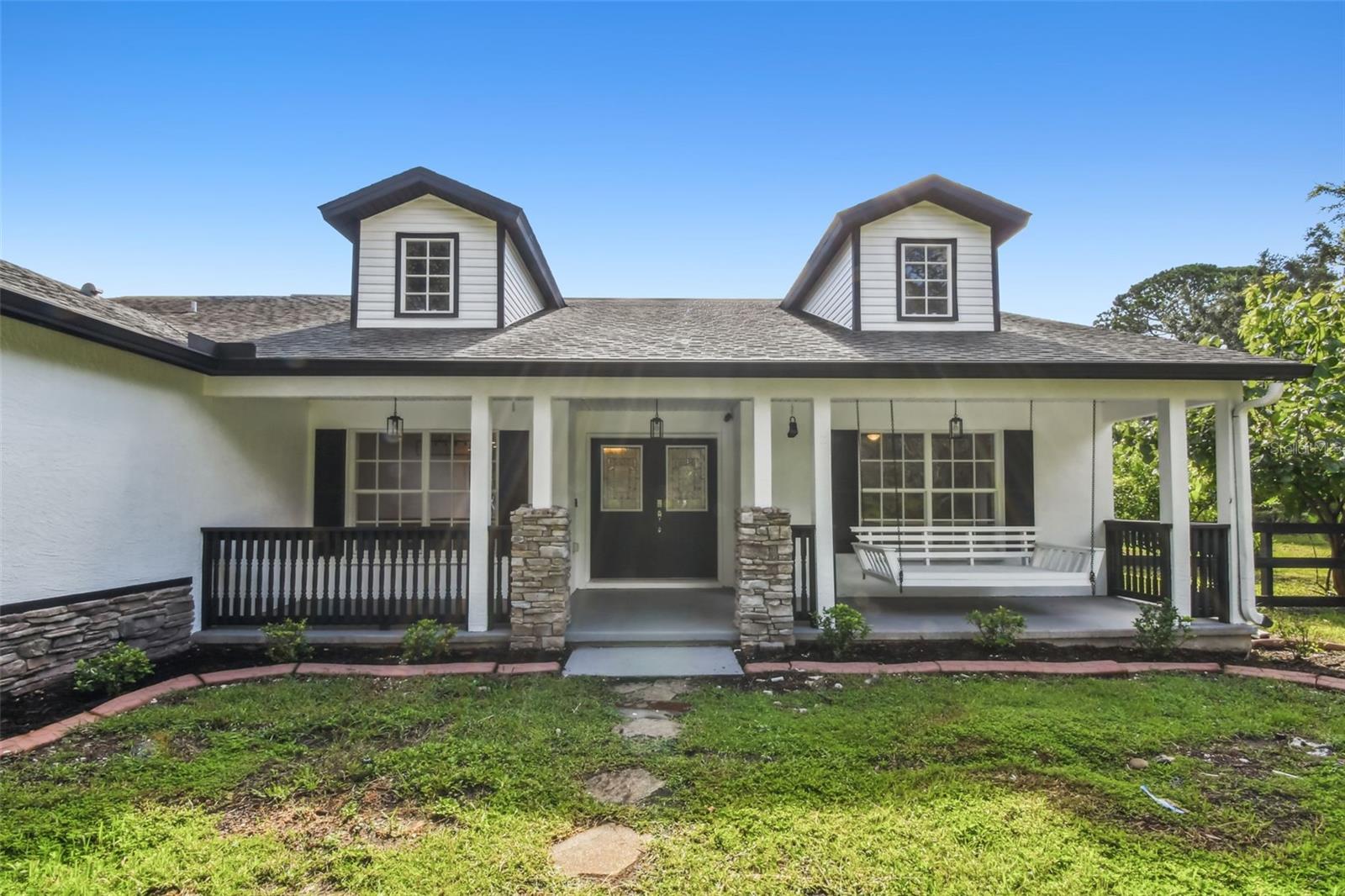 ** Now Listed Below Appraised Value**  Welcome to refined country living at its finest, where tranquility and elegance meet just 20 minutes from the vibrant heart of downtown Tampa. Set on a sprawling 4.29-acre estate, this fully renovated 5-bedroom, 2-bathroom residence offers the best of both worlds: the charm of wide-open spaces and the convenience of city access. From the moment you arrive, a picturesque front porch with a classic swing sets the stage for a home that is as inviting as it is impressive.

Step inside to discover an open-concept floor plan graced with soaring ceilings and wood-look tile flooring throughout. A formal dining room awaits at the front, while the living room draws you in with a striking stone electric fireplace that flows seamlessly into the chef-inspired kitchen. Quartzite counters, stainless steel appliances, a built-in wine rack, and a dedicated wine fridge make this kitchen an entertainer’s dream. An eat-in breakfast nook overlooks the pool and bonus flex space, creating a perfect balance between relaxation and functionality.

The oversized owner’s suite is a retreat of its own, featuring a spacious walk-in closet, French doors opening to the lanai, and a spa-like ensuite with dual vanities, a soaking tub, and a glass-enclosed shower. With a split bedroom layout, the guest quarters and modern bath ensure both privacy and comfort for family and friends.

Double sliding glass doors reveal your private outdoor oasis. A pavered, screened-in lanai showcases a heated pool and spa. Beyond, endless opportunities await with fully fenced grounds, a brand-new firepit area, storage building with workshop and stalls for livestock, a goat pen and even a chicken coop. Bring your boats, RVs, and ATVs because this property was designed to embrace it all.

Perfectly positioned near Diamond Hill Golf Course and with quick access to I-4, this estate blends elegance, space, and convenience into one unparalleled lifestyle. Do not miss the chance to experience this one-of-a-kind property, schedule your private showing today.