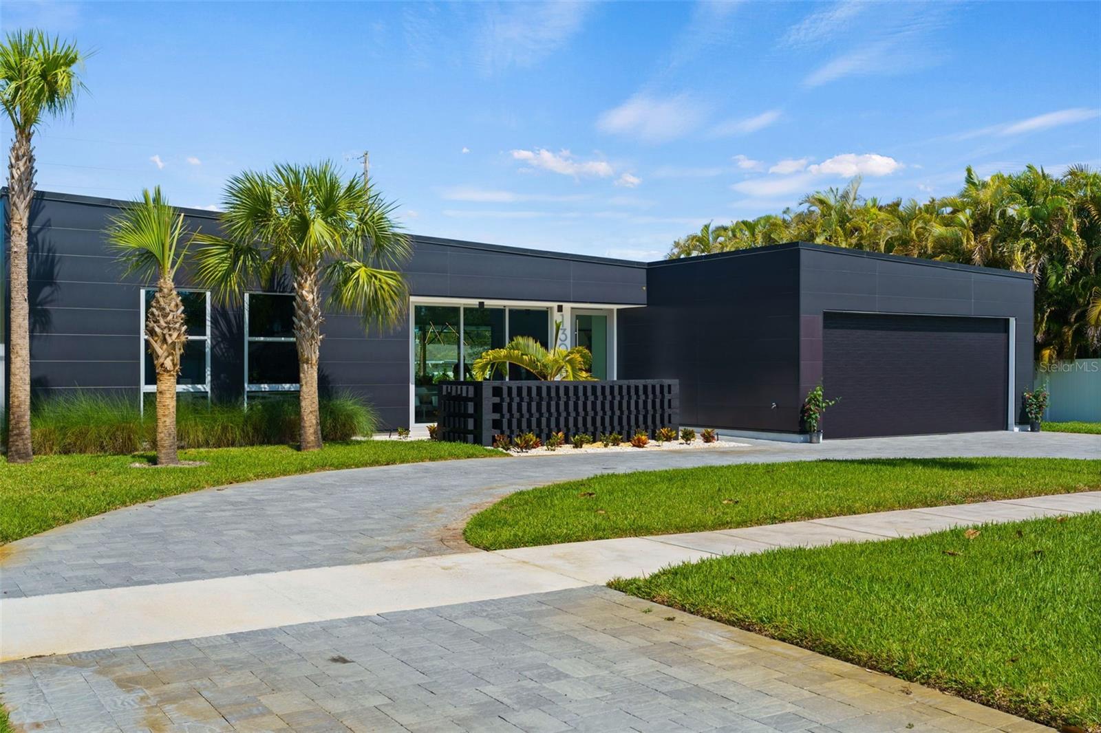 This Stunning Belleair Home has Hollywood Hills written all over it! Experience the carefree lifestyle you've been dreaming of in this modern marvel. Located in the alluring Town of Belleair, this home is just a golf cart ride away from the iconic Pelican Club and the Historic Belleair Country Club. Take a stroll on the neighborhood sidewalks to the Community Parks and Sport Courts reserved exclusively for the residents of Belleair. This exquisite four-bedroom pool home was imagined by a Beverly Hills designer and constructed with care in one of Pinellas County’s most Charming Communities. Located in a non-evacuation zone and built to enjoy and withstand all of nature’s elements! Concrete composite exterior cladding combines exceptional protection from the elements with resilient sustainability. The ten foot ceilings and impact glass windows flood the space with glorious light. From the courtyard entry, the main living area is a wide-open space drawing the inside out and the outside in. This space includes a state-of-the-art kitchen with waterfall quartz countertops over a large center island, creating a sleek backdrop for the high-end appliances. The great room has six sliding glass panels that open to a covered sanctuary and resort style pool. The primary suite has access to the pool, an ensuite bath and two walk-in closets. The primary spa bath has a walk-in tiled shower, a generous soaking tub and a floating double vanity. The second suite has a view of the pool, a walk-in closet and a private ensuite bath with glass enclosed shower. The third and fourth bedrooms each have custom closets and share a luxurious full bath. The party bath for guests is a surprising contrast of matte black in this otherwise neutral palette. Beyond the kitchen, following a wall of built-in pantry cabinets, the large laundry room has loads of storage space and provides a mudroom entry from the attached two car garage – keeping this minimalist home more organized than you ever thought possible. The outdoor living space flows seamlessly from the great room and bedroom suites, offering additional square footage in this year-round oasis. Covered Living and Dining areas and an Outdoor Kitchen lend elegant poolside entertainment. Windows are tinted for privacy and energy efficiency. Natural gas powers the range, water heater, pool heater and BBQ grill. This Belleair Home is just minutes from Belleair Beach and St. Pete Clearwater International Airport. Just a thirty-minute drive to Downtown St. Petersburg or Tampa.