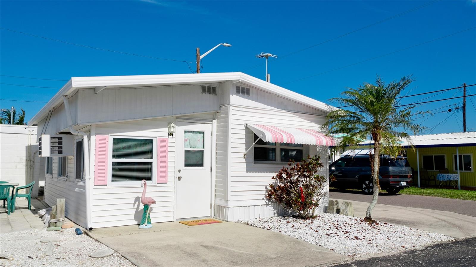 This adorable 1 bedroom 1 bath home is turnkey ready for you! Lovingly known as the "Pink Flamingo", residents love to name their homes in this neighborly community. Perfect as a seasonal retreat or after 2 years of ownership, a great income producing investment. Enjoy a living room that runs the full length, from front to back, just 2 steps up, puts you into your eat in kitchen & dinette area. Towards the back of the home, you have a full bath, complete with a soaking tub then the bedroom, comfortably located in the rear of the home. Plenty of natural light enhances the beauty and ambiance of #31 1st St. Parking pad site on the right hand side will accommodate a large SUV, on the left side there is a patio with a table for outside gatherings with your friends & yummy picnics. You can also use this area to park your golf cart which is a favorite mode of transportation within the park along with bicycles.
In the rear of the patio, there is a storage room that would make a great outside shower or laundry as many have done. There is also a full community laundry facility, just one block from this home for your convenience. For boating enthusiasts, boat slips are available to rent on a first come basis. Paradise Bay has multiple docks to launch your craft, jet ski or kayak, that are just for the residents. Having Sarasota Bay just a block from this home, it's an easy stroll to head down to one of the park benches or covered swings to enjoy a magical sunset. Here it's more of an "event" when you see how many folks have the same idea & head down to the waterfront every evening to observe Mother Natures Splendor. This community has numerous events planned on the community calander, just head down to the clubhouse & plan out your activities for the month. Also enjoy a beautiful pool, bocci ball, pickle ball & tennis courts for a friendly competition with your friends.
If you should decide to venture out. You are less then a 10 minute ride to put your toes in the soft sandy beaches of Anna Maria Island. An abundance of restaurants, shopping, golf courses, spring training, fishing & boating charters, multiple airports & cruise ports are also nearby. Come see for yourself & make this move in ready home your new address! Paradise Bay is a 55+ Community.