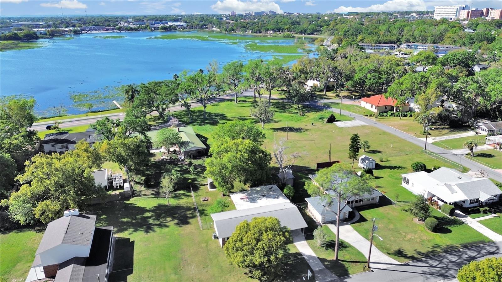 MOTIVATED SELLER!!!!! New Better Price improvement. Make an appointment ASAP because this adorable home won't last! NO HOA, water views, tons of charm. Only four houses away from Lake Parker..You can watch the sunrise and view Florida wildlife from your front or back porch! You will be close to medical facilities, Lakeland Square Mall, Publix, and have easy access to I-4. If you like boating, you're in luck! There's plenty of room to park your boat - and the Lake Parker public boat ramp is just around the corner! You'll absolutely love the spacious bonus room. Currently being used as the master bedroom, the possibilities are endless. With a sound proof ceiling perhaps it would make a great music room! And wait, there's more! This home boasts a gorgeous NEWER KITCHEN with soft close cabinets and stainless appliances ,  new roof (2022). and the house was replumbed in 2010. The master bathroom has a new shower and the main family bath is the cutest retro original bathroom. HOME WARRANTY IS OFFERED FOR THE FIRST YEAR PEACE OF MIND.