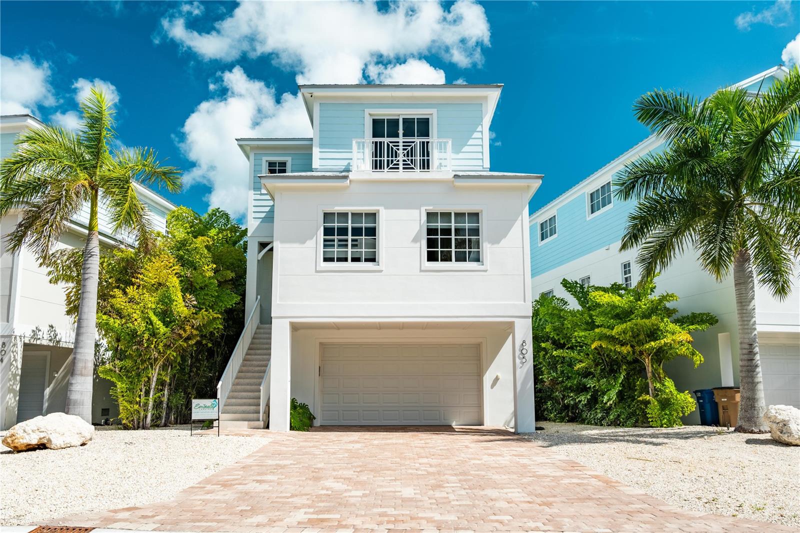 LOCATION LOCATION LOCATION DIRECTLY ON THE GULF W/ GULF OF AMERICA AND MARINA VIEWS! Welcome to an extraordinary opportunity to own a newly constructed, luxury waterfront residence in the heart of the Florida Keys. Located in the exclusive Emerald Landings community in Marathon, this exceptional home offers breathtaking open-water views, a private 50'  boat slip included, and a rare private beach, kayak launch, blending high-end coastal living with unmatched boating convenience. Thoughtfully designed for both luxury and functionality, this stunning property features 5 bedrooms and 5 bathrooms, including two spacious primary suites with private balconies overlooking the water. An open-concept floor plan showcases a chef's kitchen with quartz countertops and waterfall island, seamlessly flowing into the living and dining areas--ideal for entertaining or relaxing with panoramic sunset views. Outdoor living is elevated with a heated resort-style pool, expansive patios, and multiple spaces designed for al fresco dining and sunset gatherings. Premium finishes, coastal-inspired design, and modern technology are found throughout the home, offering a turn-key experience for owners and guests alike.This property is the perfect investment opportunity, boasting a proven short-term rental history and strong income potential, while also serving as an ideal future personal residence for those dreaming of a private retreat in the Keys. Whether used as a high-performing vacation rental, a seasonal escape, or a full-time waterfront home, this property offers unmatched versatility. Centrally located near world-class boating, dining, shopping, and beaches, this rare offering combines luxury, location, and lifestyle--a true Keys dream home with income-producing potential. Being offered furnished.